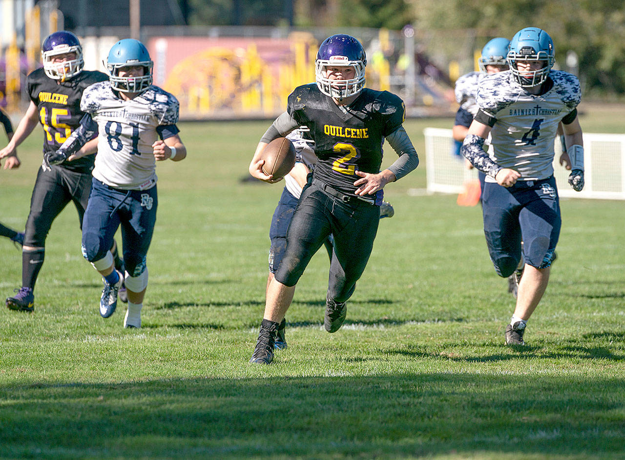 Steve Mullensky/for Peninsula Daily News Quilcene’s Bishop Budnek picks up a first down during a game against Rainier Christian. Budnek is one of three 1,000-yard rushers on the North Olympic Peninsula.