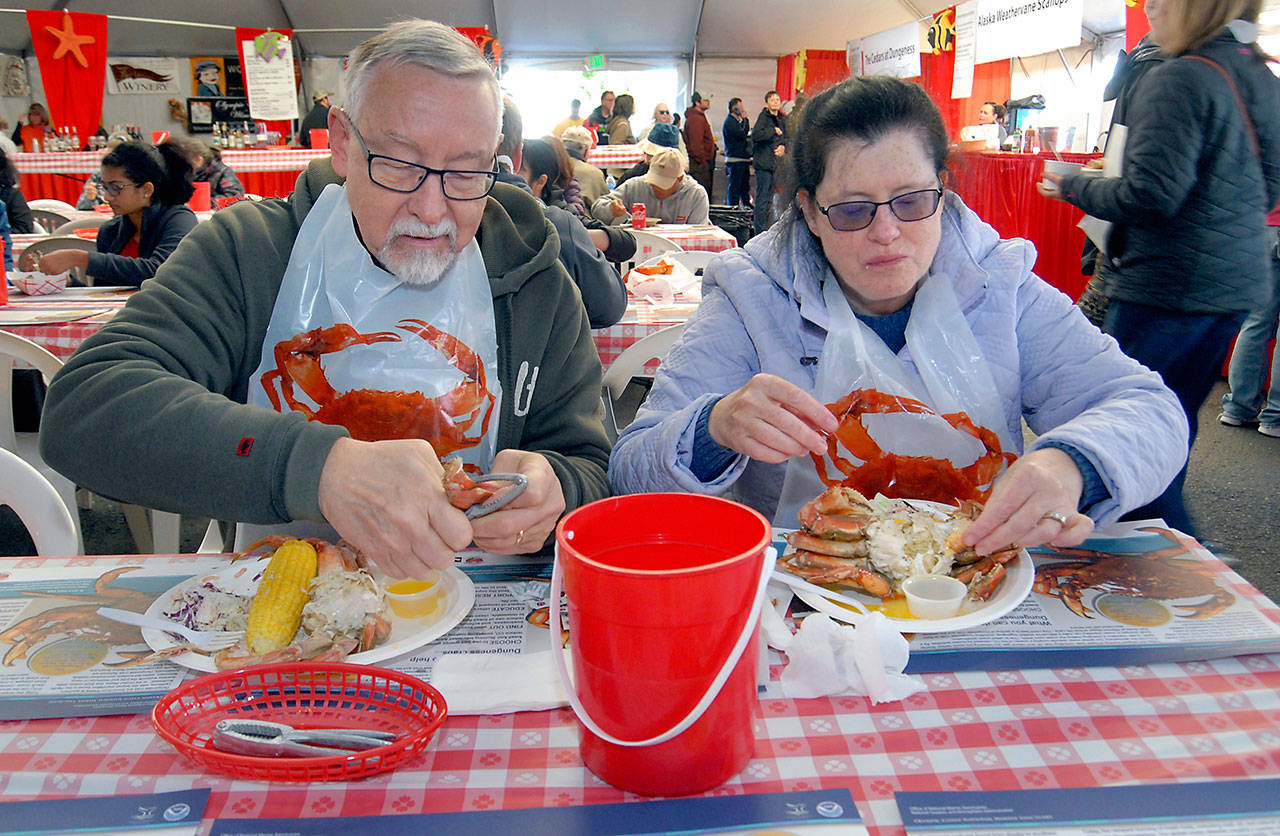 John and Darcy McTernan of Kirkland enjoy a crab dinner in the Dungeness Crab and Seafood Festival main tent in the parking lot of the Red Lion Hotel. (Keith Thorpe/Peninsula Daily News)