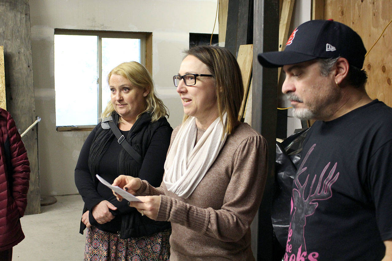 Haunt Town Director Steve Spencer, right, and “Haunt Mom” Christy Spencer give an overview of the scenes within the haunted house to a group of volunteers and supporters during their Thursday night rehearsal in the Basement of the Elk’s Lodge. (Zach Jablonski/Peninsula Daily News)