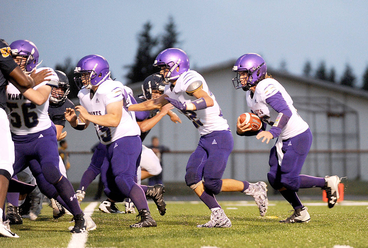 Sequim’s Taig Wiker, far right, runs the ball against Forks early this season. (Michael Dashiell/Olympic Peninsula News Group)