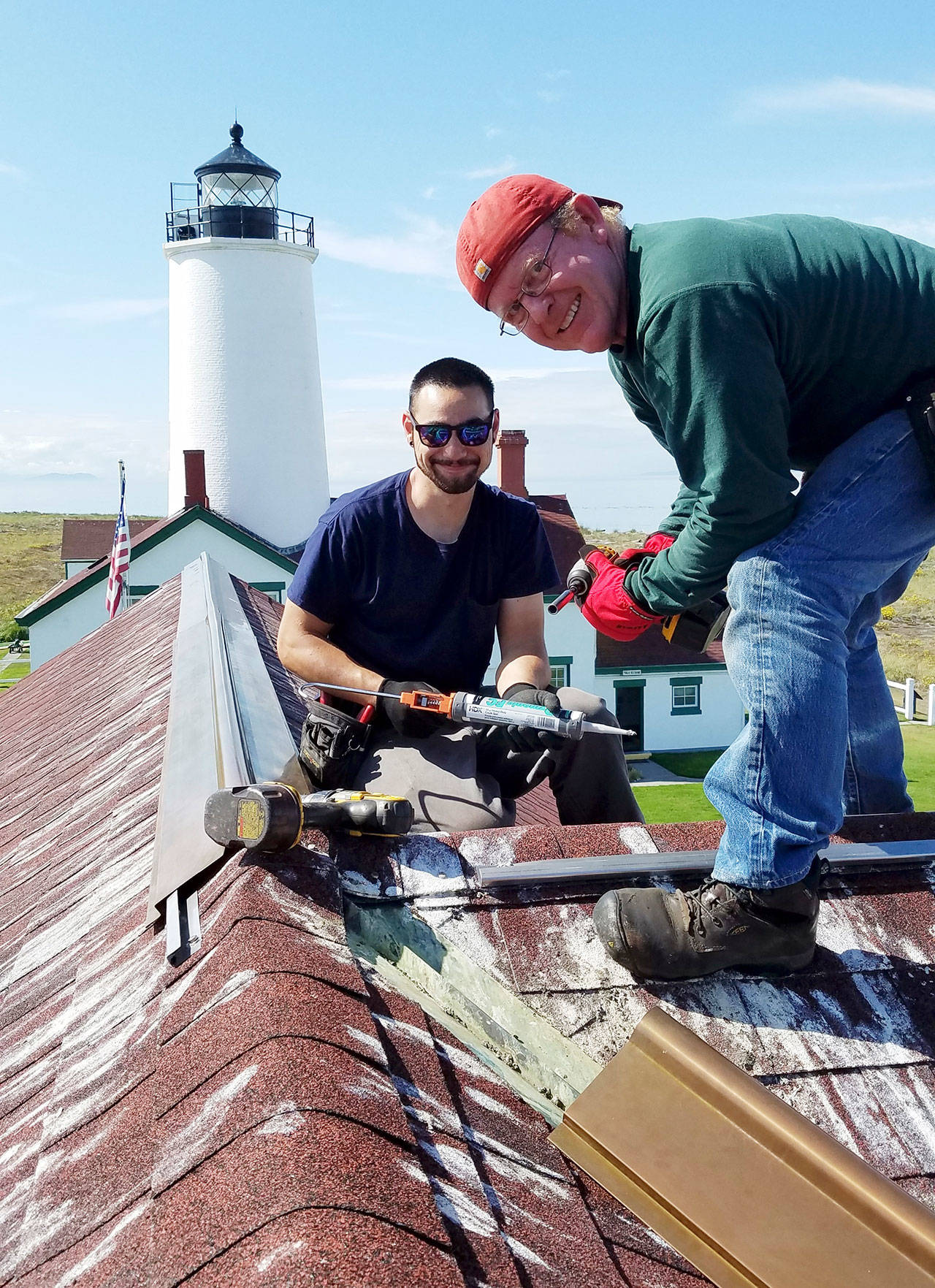 Volunteers spruce up the New Dungeness Light Station during an annual work week effort in mid-September. The New Dungeness Light Station Association will host its annual meeting Saturday. (New Dungeness Light Station Association)