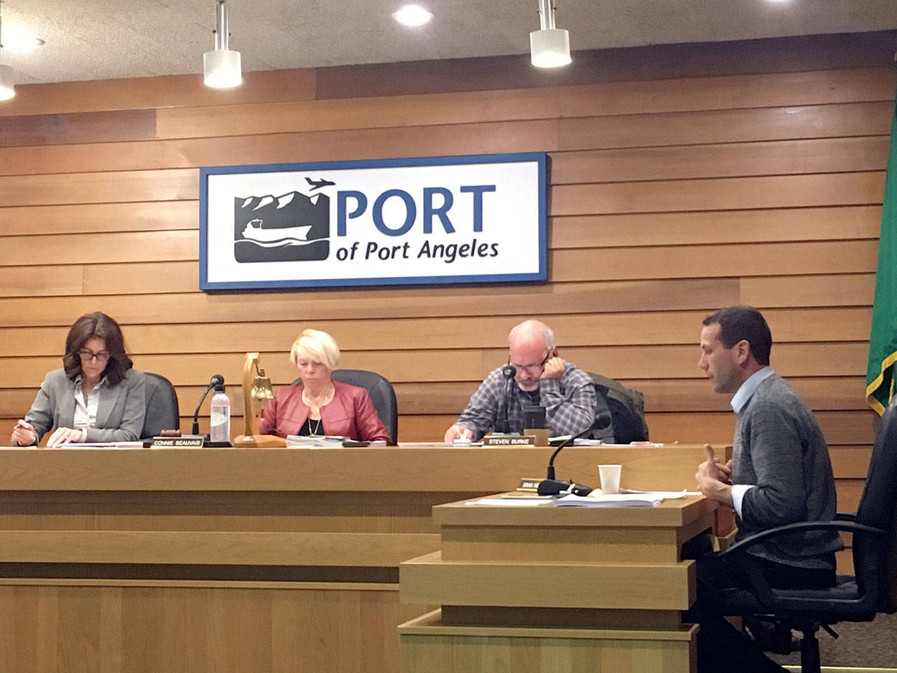 Port of Port Angeles attorney Brian Wendt, right, explains a settlement agreement with Shell Oil that commissioners Colleen McAleer, left, Connie Beauvais and Steve Burke approved unanimously at Tuesday’s port commission meeting in Port Angeles. (Rob Ollikainen/Peninsula Daily News)