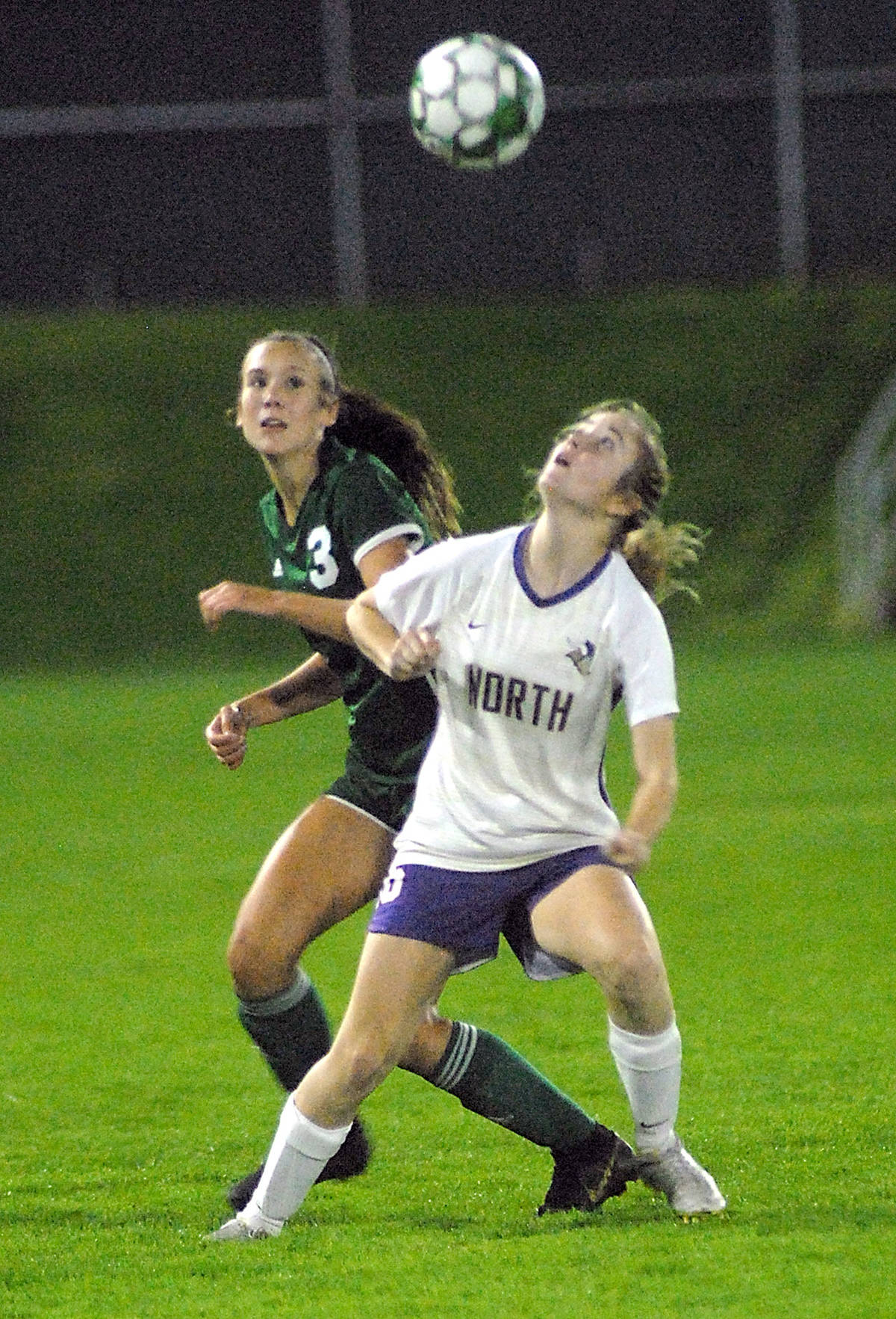 Port Angeles’ Hannah Reetz, left, and North Kitsap’s Sarah Hamilton vie for a header Thursday night at Port Angeles Civic Field. (Keith Thorpe/Peninsula Daily News)