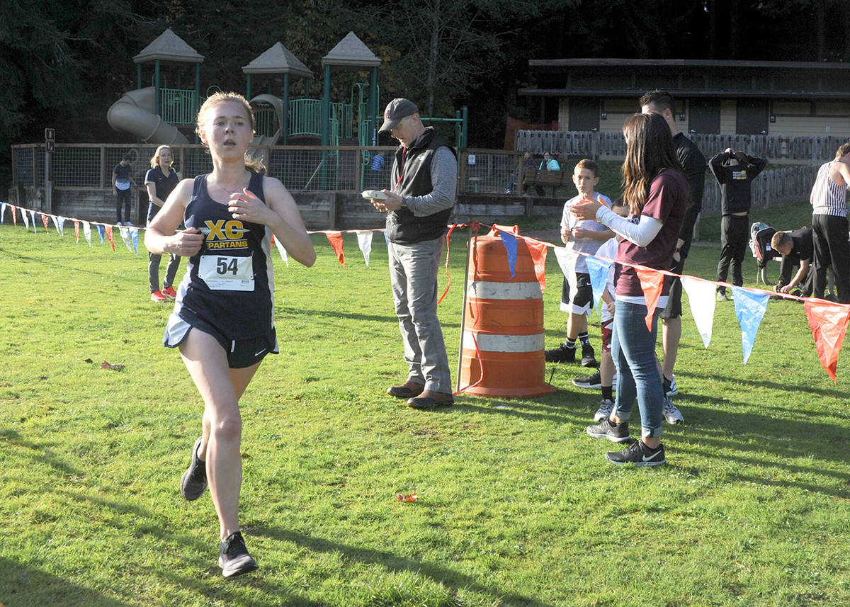 Ryan Sparks/Grays Harbor News Group Forks’ Madelyn Archibald crosses the finish line at Lake Sylvia State Park in Montesano on Thursday taking the 1A Evergreen League championship.