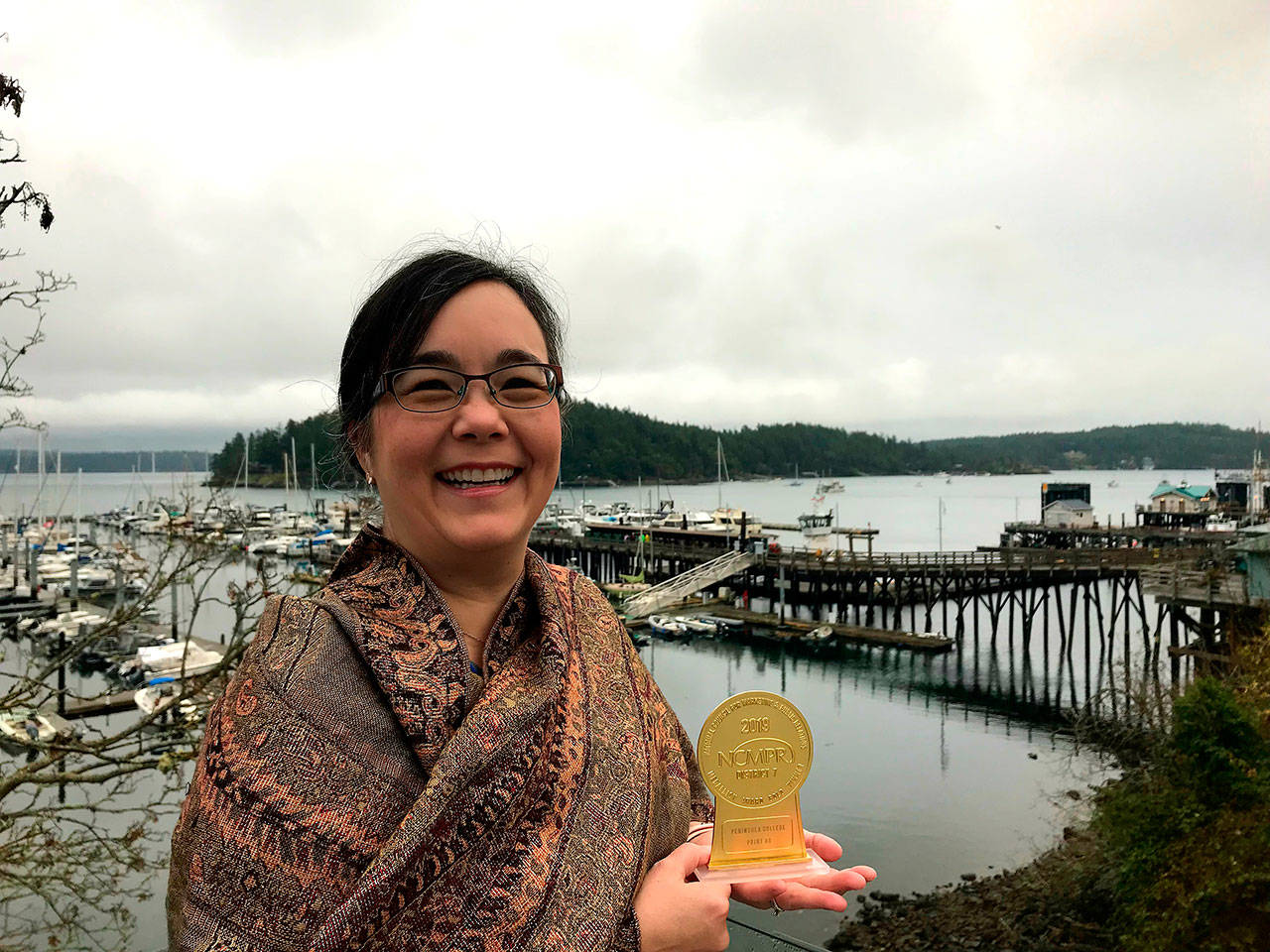 Grace Kendall, Peninsula College’s director of marketing, receives a gold medallion award at the recent District 7 National Council for Marketing and Public Relations Conference, held in Friday Harbor. (Peninsula College)