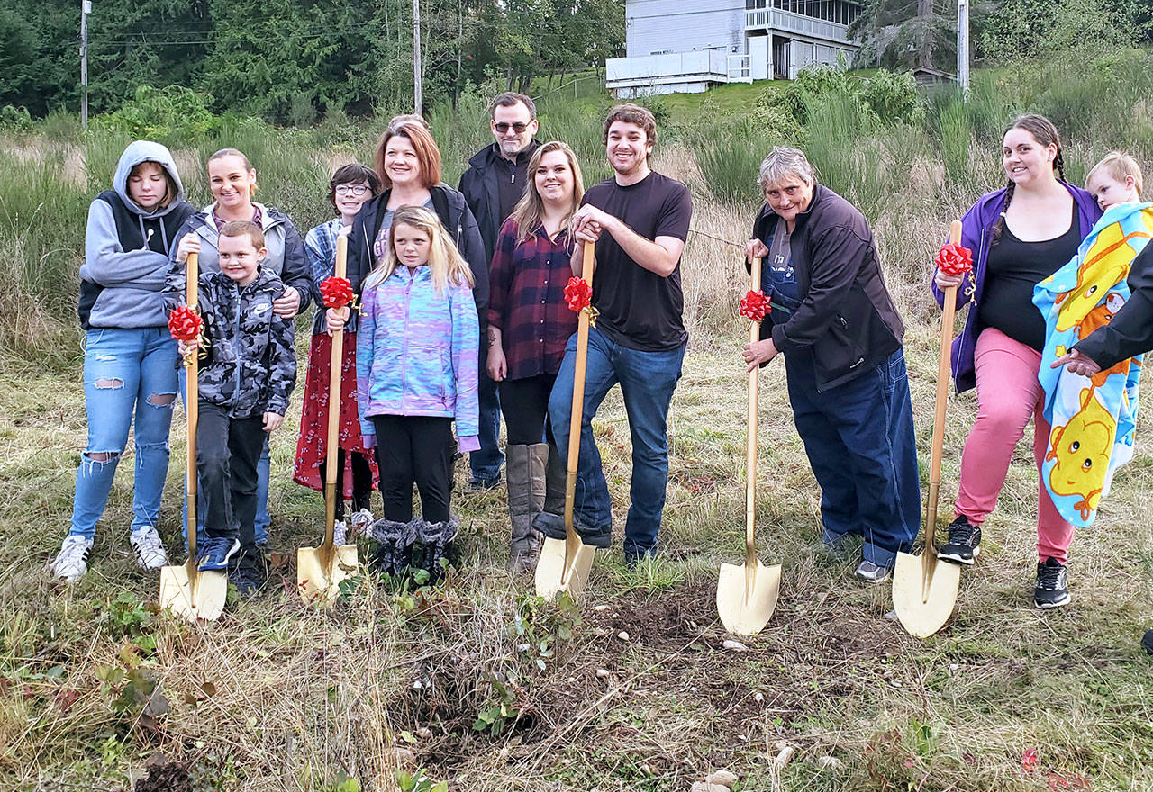 Homebuilders in the Mutual Self Help Housing Program of the Peninsula Housing Authority pose at a ceremonial groundbreaking on West 11th Street in Port Angeles. From left are Shalynn Weis, Monica Farris with Skyer Farris, Jessamyn Schindler, Jaime Peterson with Madi Schindler, Michael Hurst, Kayla Hennings, Galen Furford, Annette West and Donelle Thomason with Griffin Rohde.