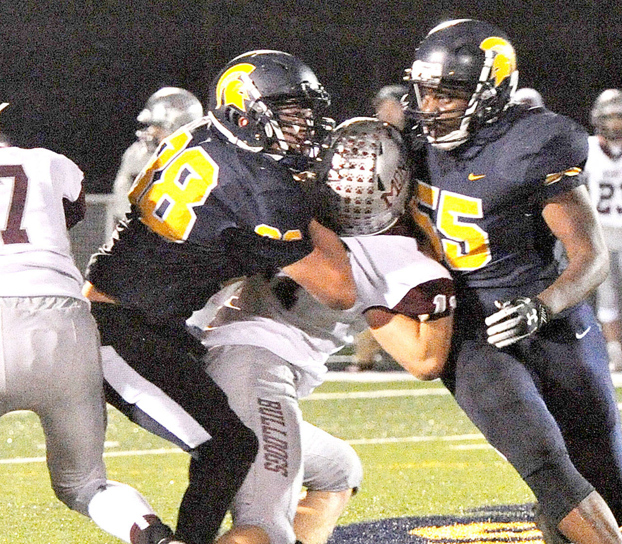 Hayden Queen (38), here making a tackle against Montesano, has been a monster on both sides of the ball for Forks. (Lonnie Archibald/for Peninsula Daily News)