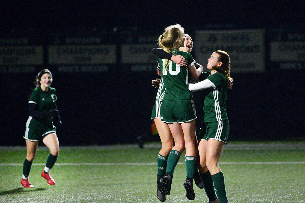 Port Angeles’ Millie Long (10), Hannah Reetz (center) and Bailee Larson celebrate scoring a goal against the Steilacoom Sentinels during a district playoff game at Peninsula College on Tuesday. (Jesse Major/Peninsula Daily News)