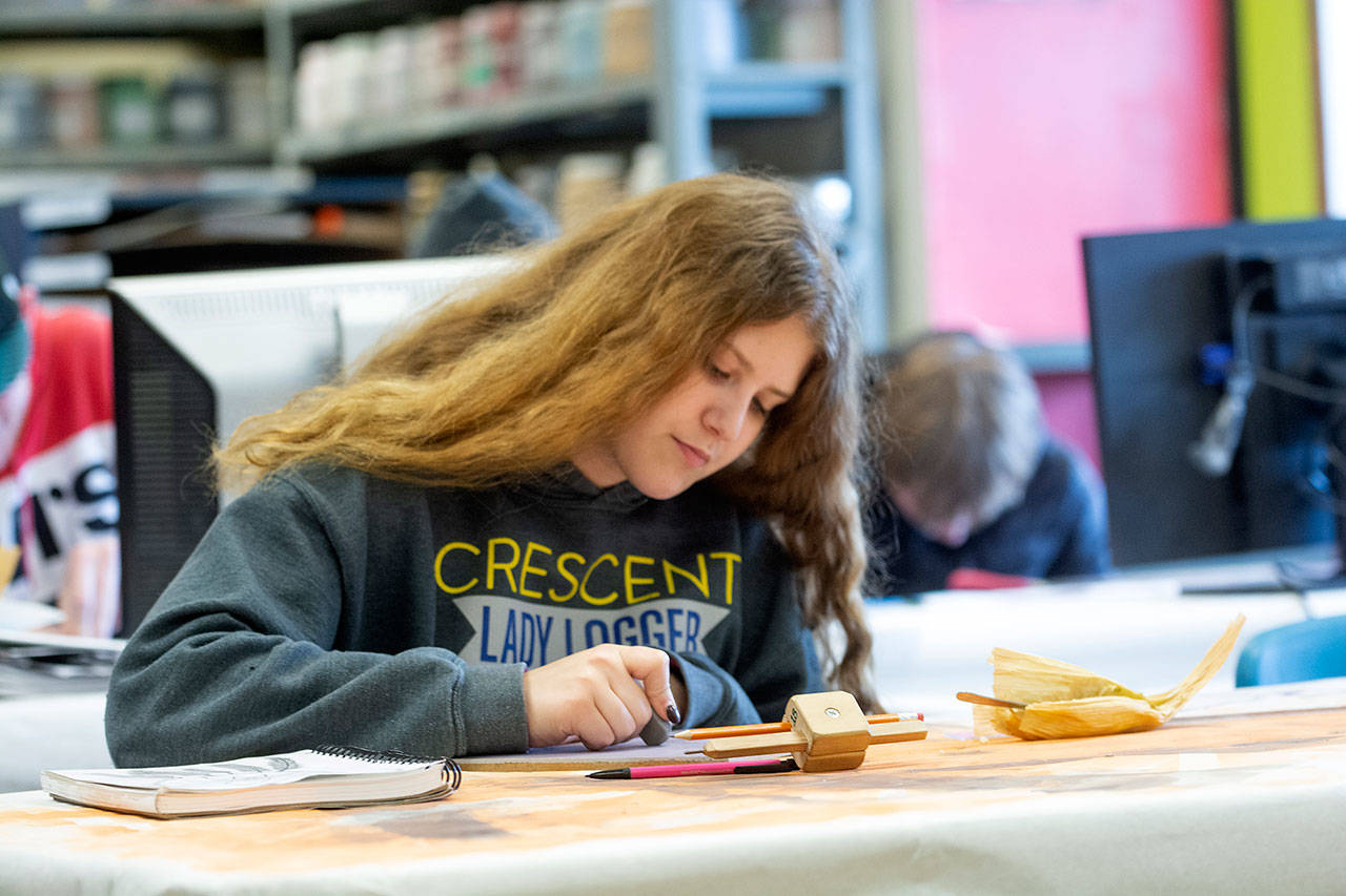 Cheyane Green, a sophomore at Crescent High School, works on an art project. (Jesse Major/Peninsula Daily News)