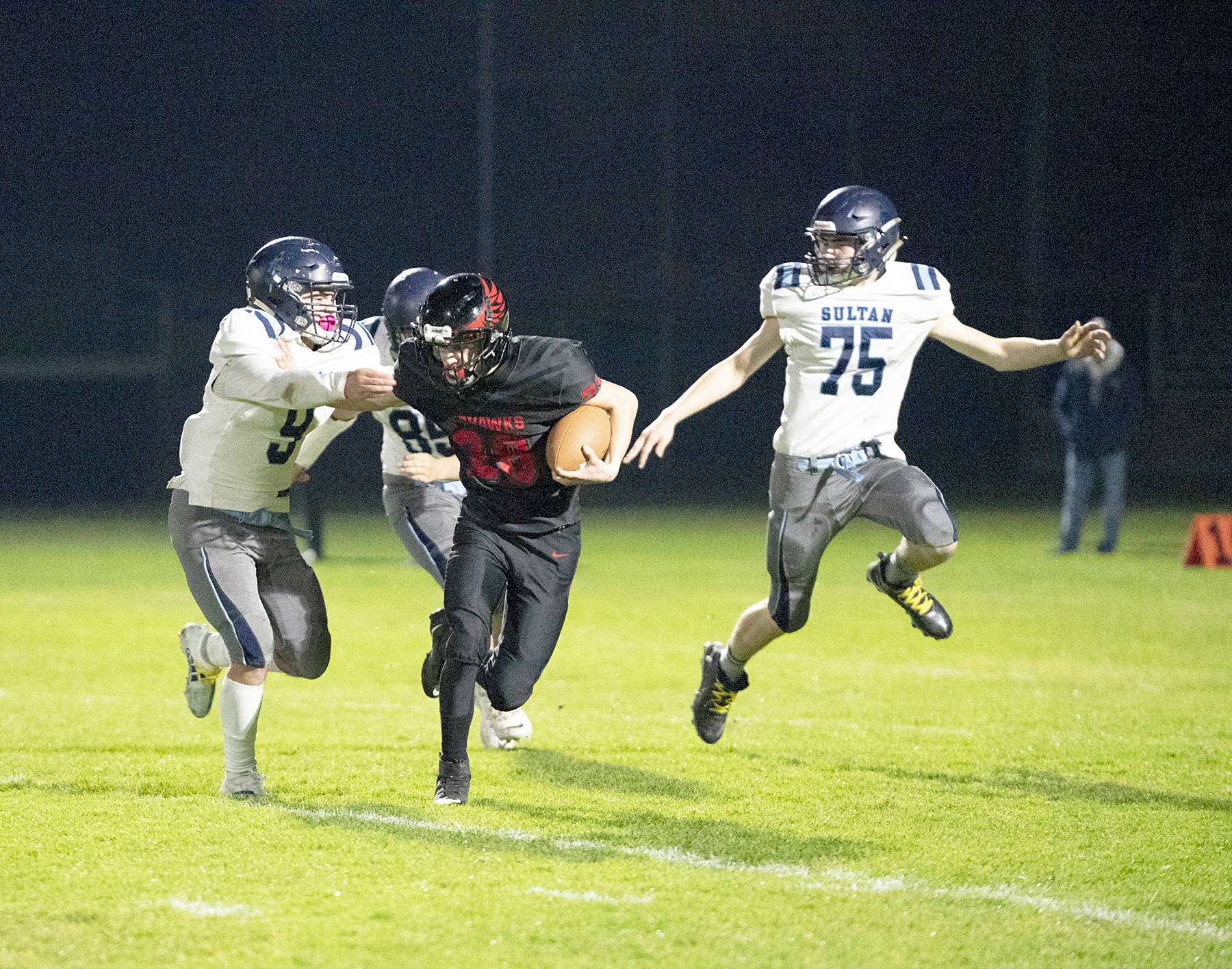 The Redhawks’ Joshua Davis (28) carries the ball against Sultan on Friday. Sultan won 68-18. (Steve Mullensky/for Peninsula Daily News)