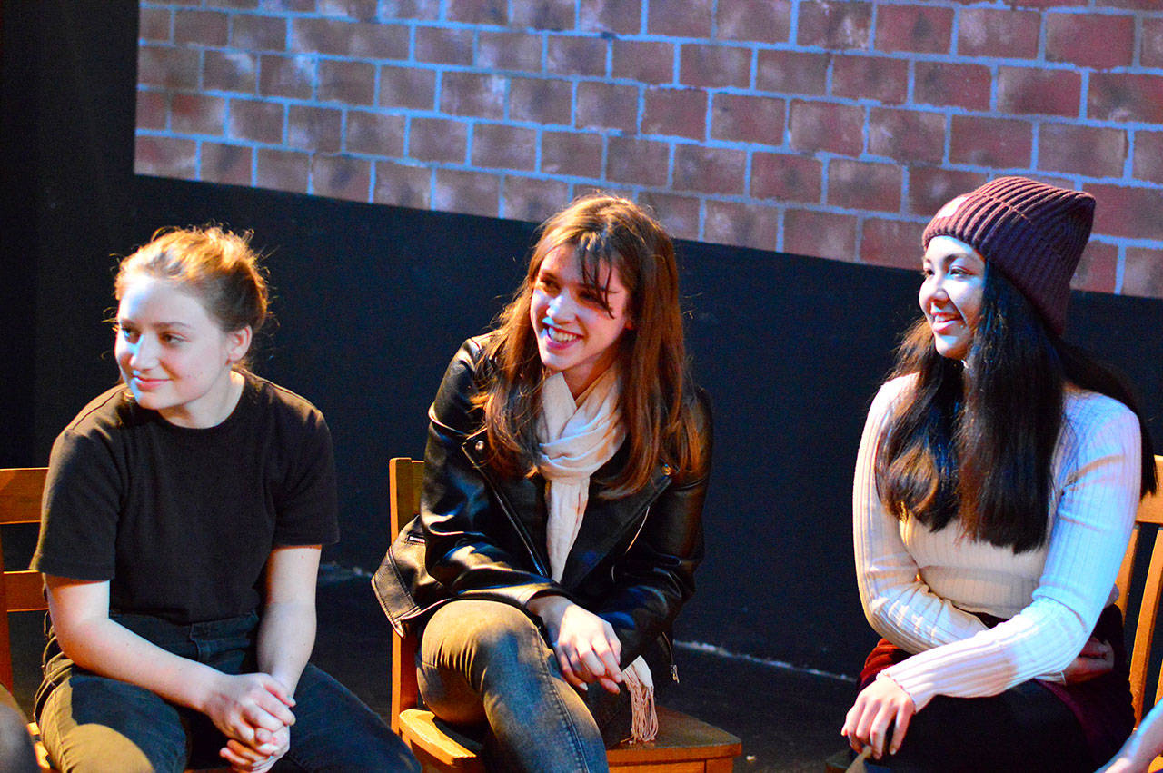 “Our Town” cast members — from left, Trillium Burbank, Pascal Sanok and Julia Neville — discuss the show before rehearsal at Port Townsend High School. (Diane Urbnai De La Paz/for Peninsula Daily News)