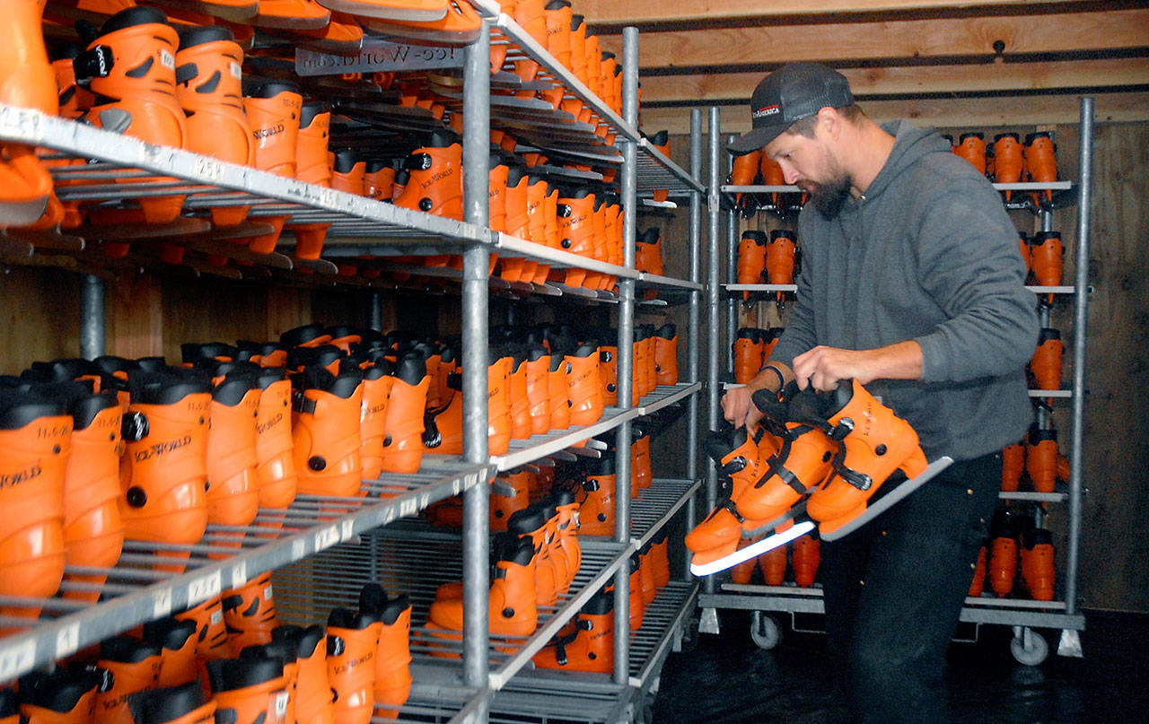 Scott Rensmon of the Harbor City, Calif.-based Ice-America organizes ice skates that will be available for rental at the Port Angeles Winter Ice Village. (Keith Thorpe/Peninsula Daily News)