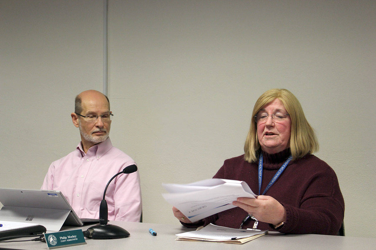 Jefferson County Administrator Philip Morley sits with Vicki Kirkpatrick, director of public health, as she presents the Five-Year Affordable Housing Plan to the county commissioners. (Zach Jablonski/Peninsula Daily News)