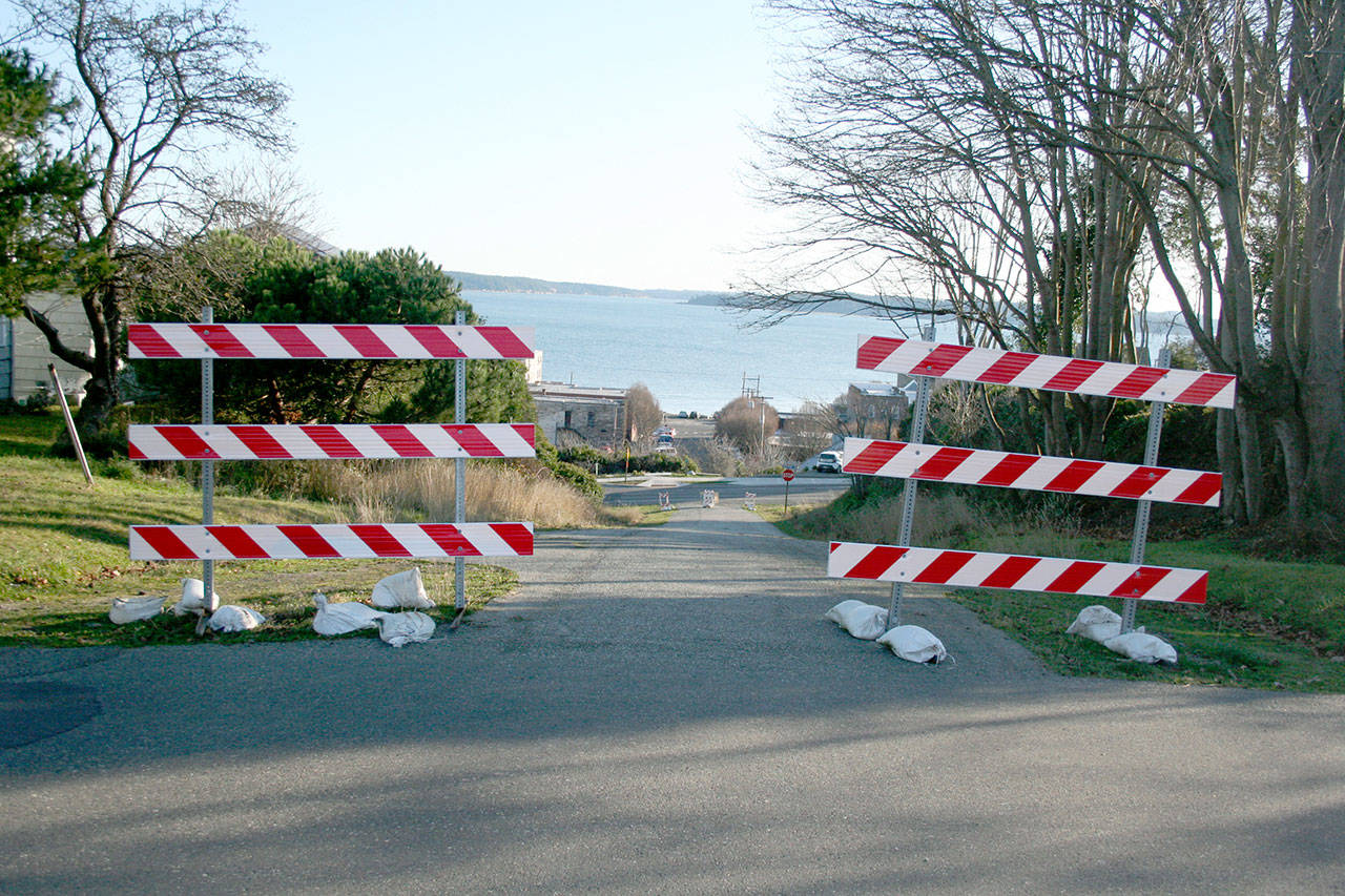 Barricades signal the closure of Adams Street in uptown Port Townsend. The street was initially closed to provide a staging area for a contractor to construct sidewalks on Jefferson Street, and now the Port Townsend City Council is weighing its options, which include reopening the street for traffic or keeping it permanently closed. (Brian McLean/Peninsula Daily News)