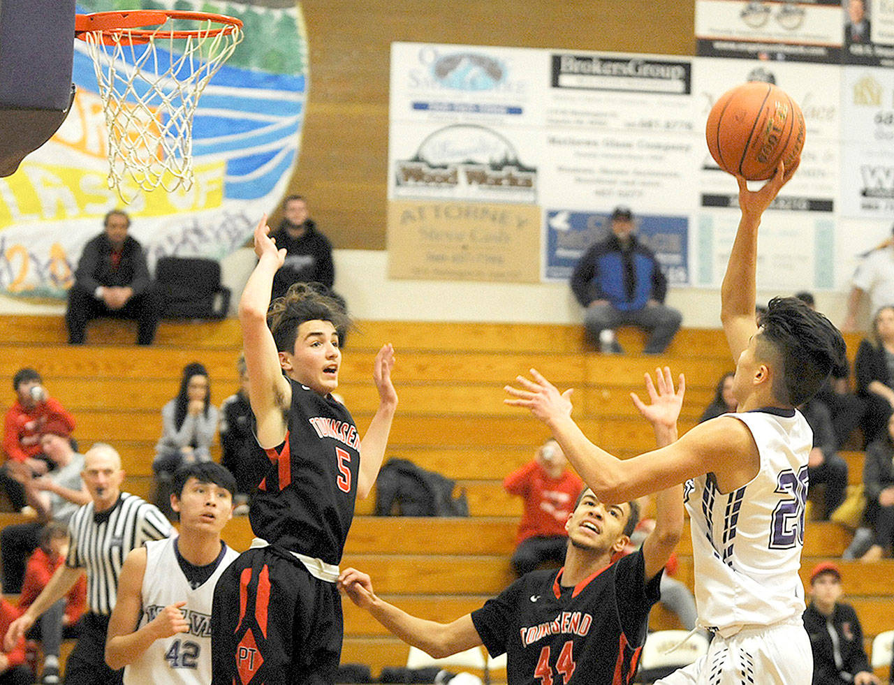 Port Townsend’s Lonnie Kenny (5) and Devin Harriss (44) defend against Sequim on Monday. (Conor Dowley/Olympic Peninsula News Group)