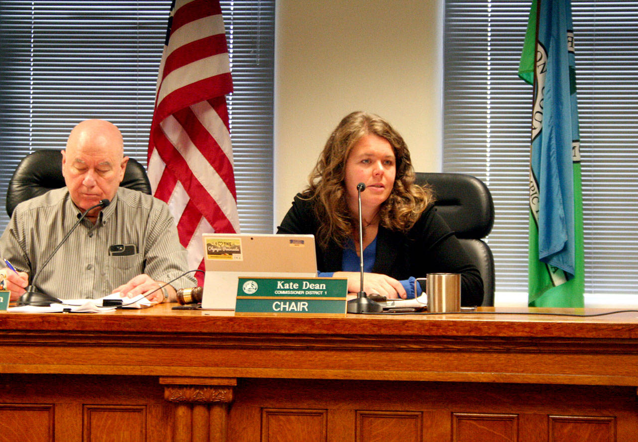 Jefferson County Commissioners David Sullivan, left, and Chair Kate Dean discuss the county’s first biennial budget Monday at the Jefferson County Courthouse. Sullivan, Dean and Commissioner Greg Brotherton also heard the planning commission’s recommendation to limit future shooting ranges to being indoors. (Brian McLean/Peninsula Daily News)