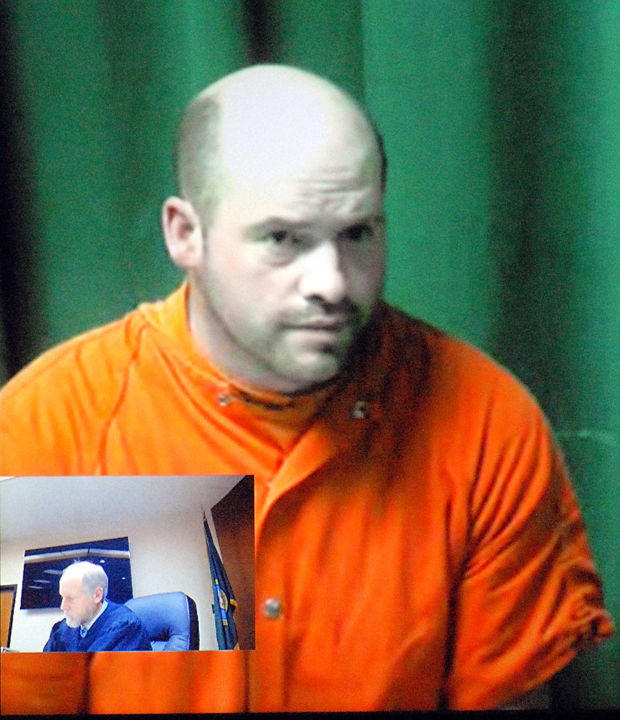 Ryan Warren Ward, 37, appears by video link during his first appearance in Clallam County Superior Court in Port Angels on Thursday on charges of aggravated first-degree murder with firearms enhancements related to a triple homicide in December.Inset in the two-way video appearance is Superior Court Judge Brian Coughenour. (Keith Thorpe/Peninsula Daily News)