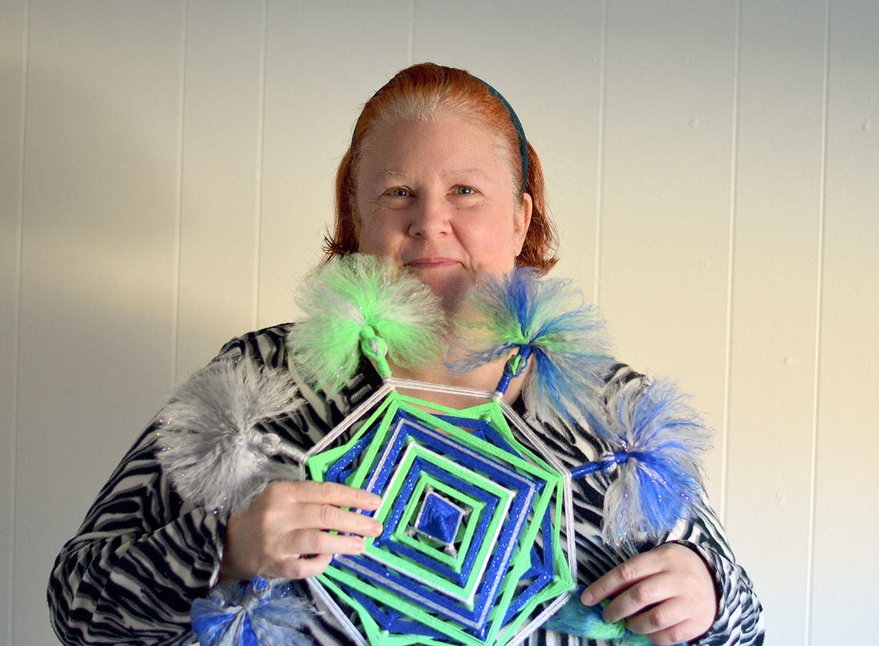 A friend made Seahawks-hued god’s eyes ornaments for Linda Perry, a devoted Hawks fan in Port Angeles. (Diane Urbani de la Paz/for Peninsula Daily News)