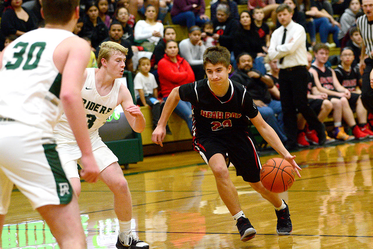 Neah Bay’s Julian Carrick runs past Port Angeles Riders during the first half of Port Angeles’ win over the Red Devils last week. (Jesse Major/Peninsula Daily News)