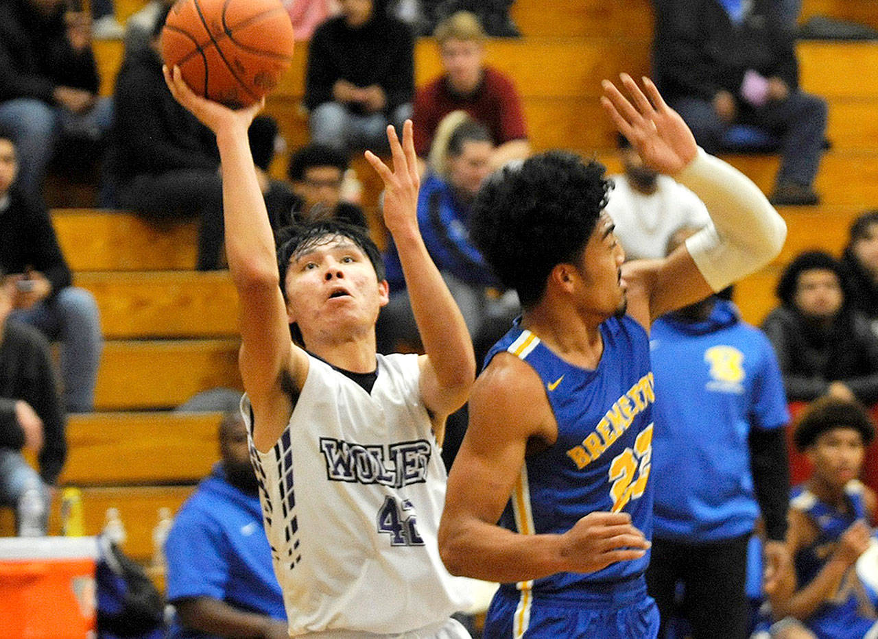 Sequim’s Isaiah Moore (42) goes up against Bremerton’s Kaipo Retome for two of his 26 points against Bremerton in Sequim on Tuesday. (Conor Dowley/Olympic Peninsula News Group)