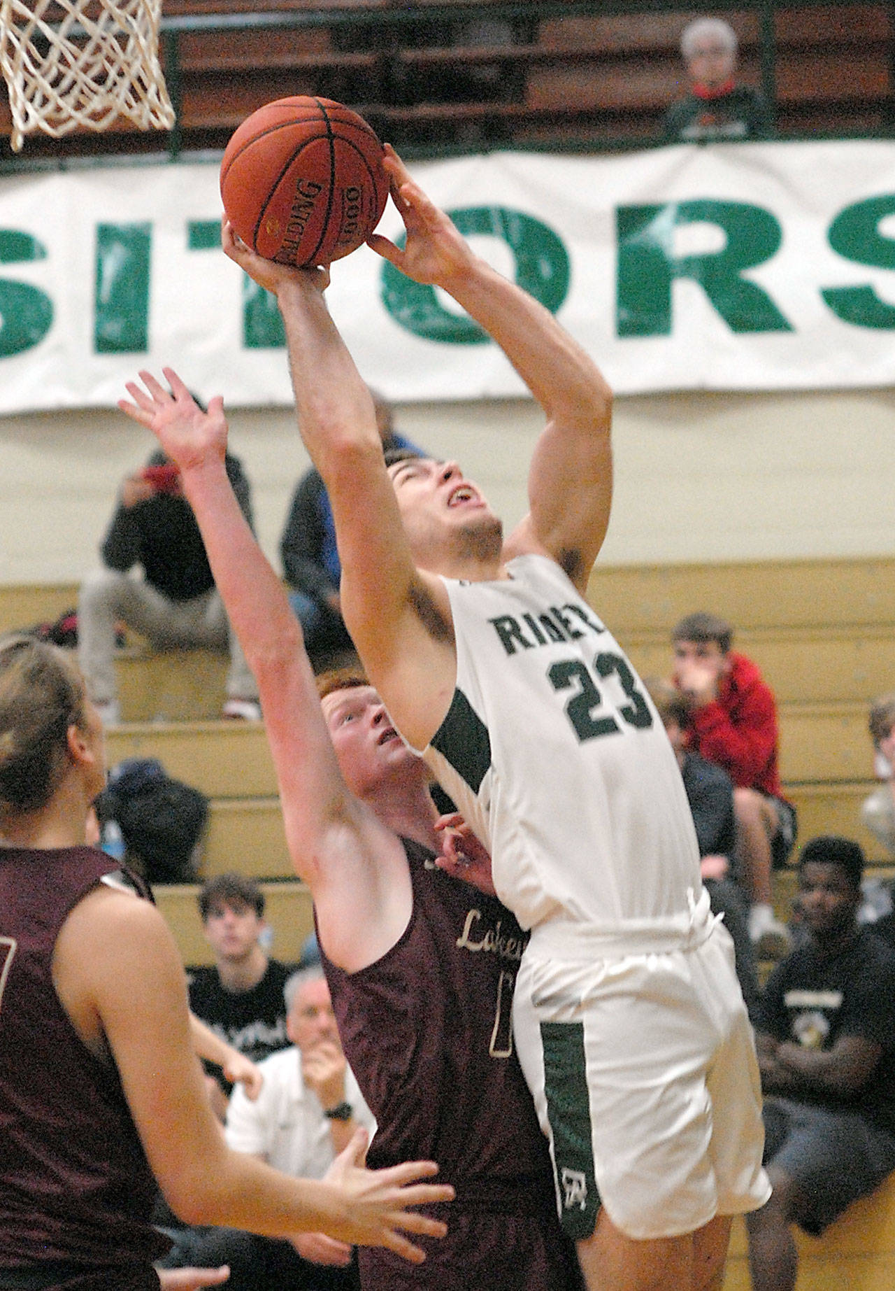 Port Angeles’ Anton Kathol stretches up for shot over Lakewood’s Alex Jensen as Lakewood’s Blake Conyers, left, looks on during Saturday’s game at Port Angeles High School. (Keith Thorpe/Peninsula Daily News)