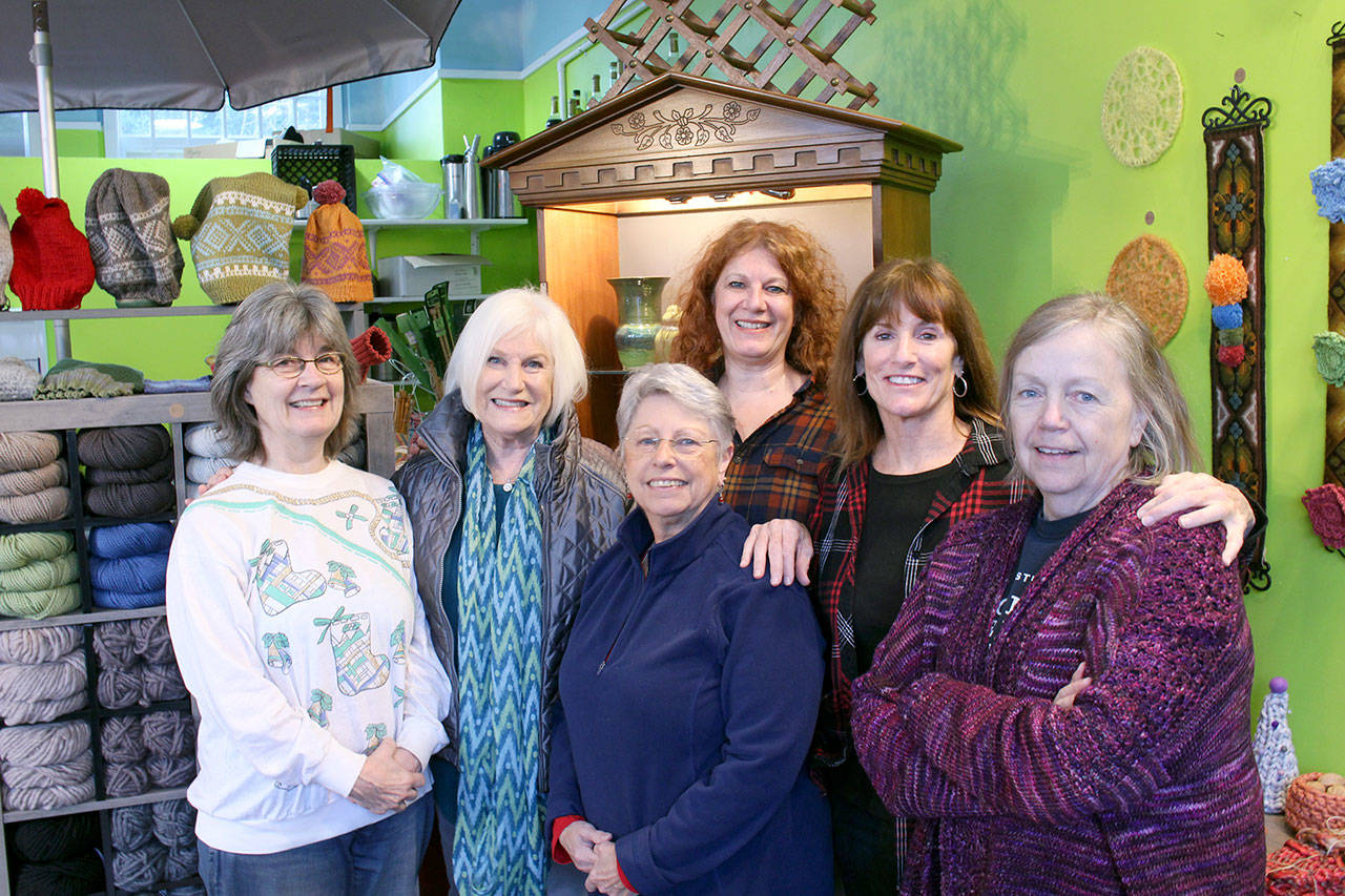 Brinnon and Quilcene Community Knitters members, from left, Nancy Nash, Pam Barnet, Jan Gillanders, Lise Solvang, Susan Stewart and Shirley McMahon are seen in Solvang’s shop Fiber and Clay in Quilcene on Thursday morning. (Zach Jablonski/Peninsula Daily News)