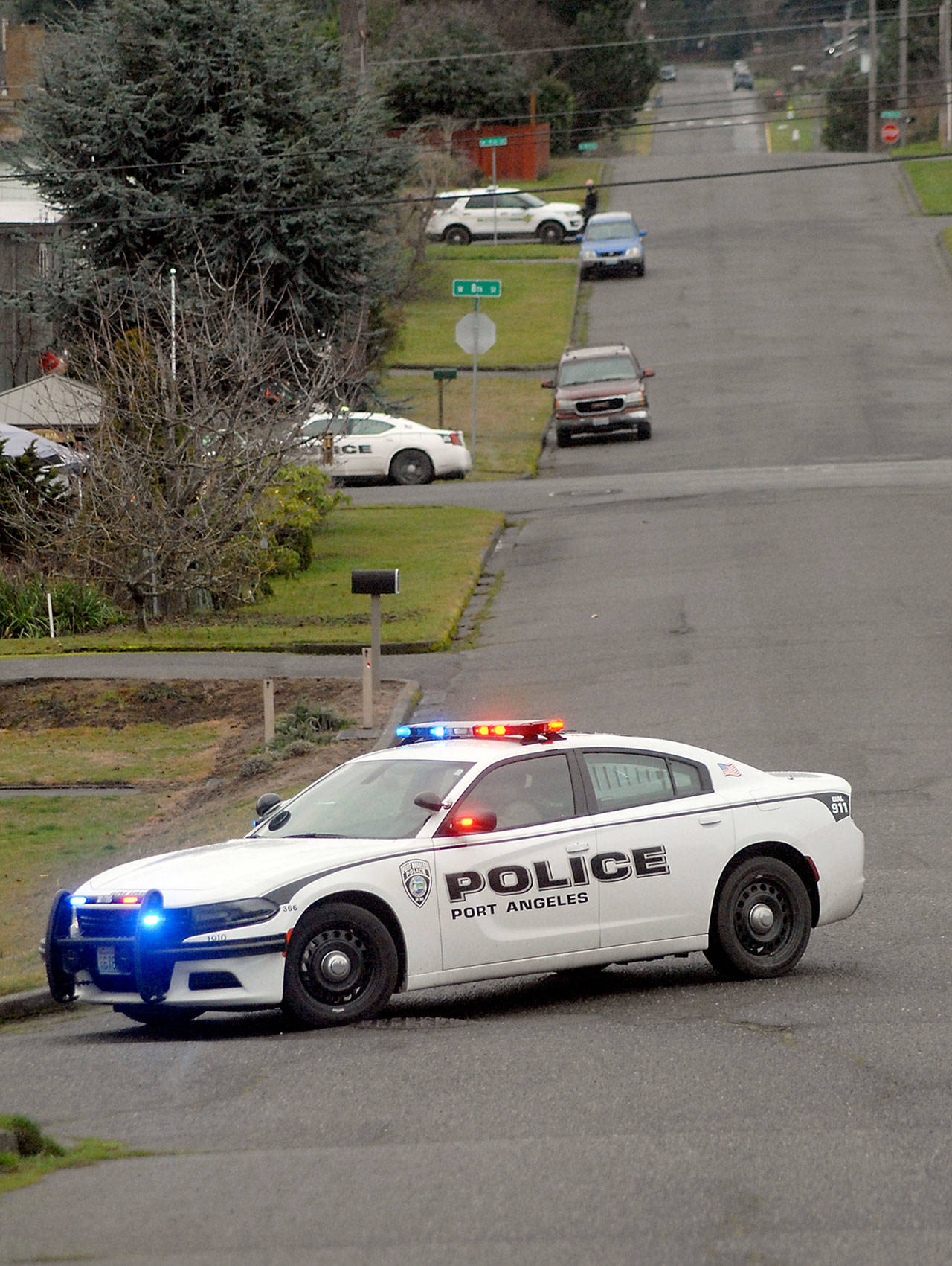 Law enforcement officers stand watch at intersections along D Street on the west side of Port Angeles on Friday. (Keith Thorpe/Peninsula Daily News)