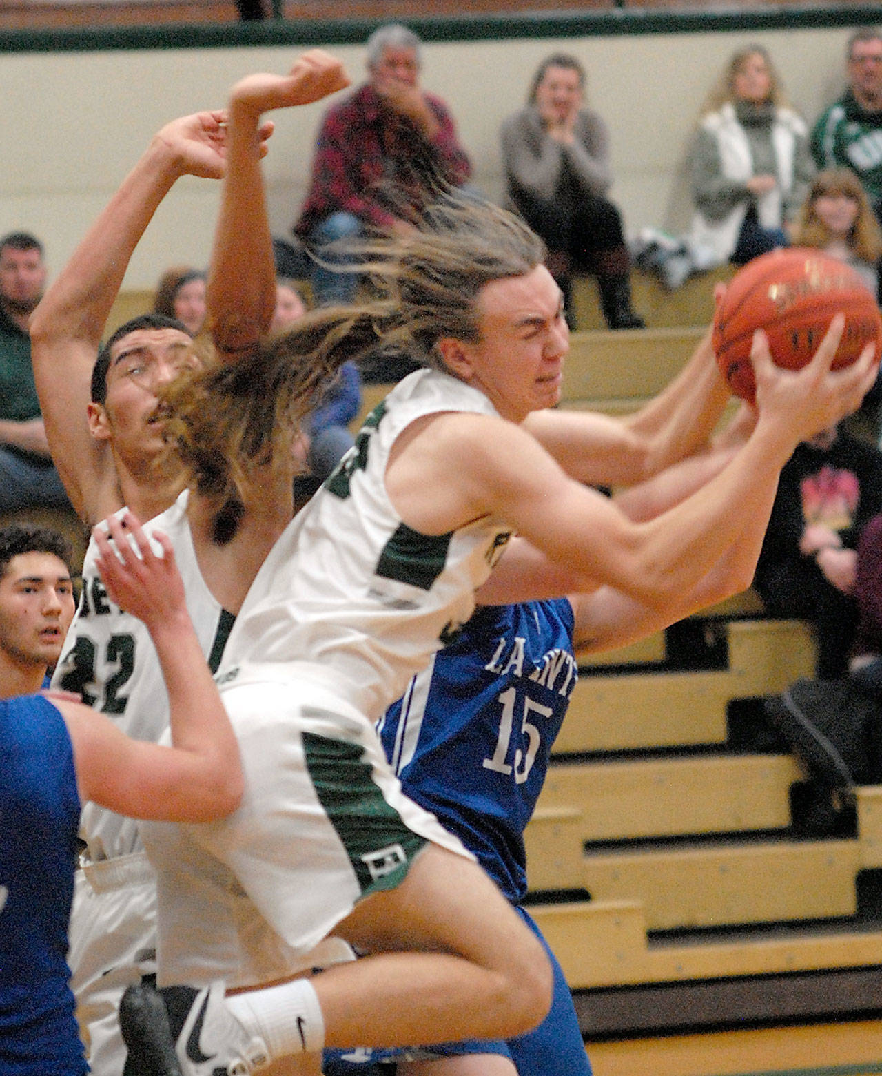 Keith Thorpe/Peninsula Daily News Port Angeles’ Derek Bowechop, front, fights for a rebound with La Center’s Riley Fender, back, as Bowechop’s teammate Damon Ringgold, left, looks on during Friday night’s non-conference game in Port Angeles.