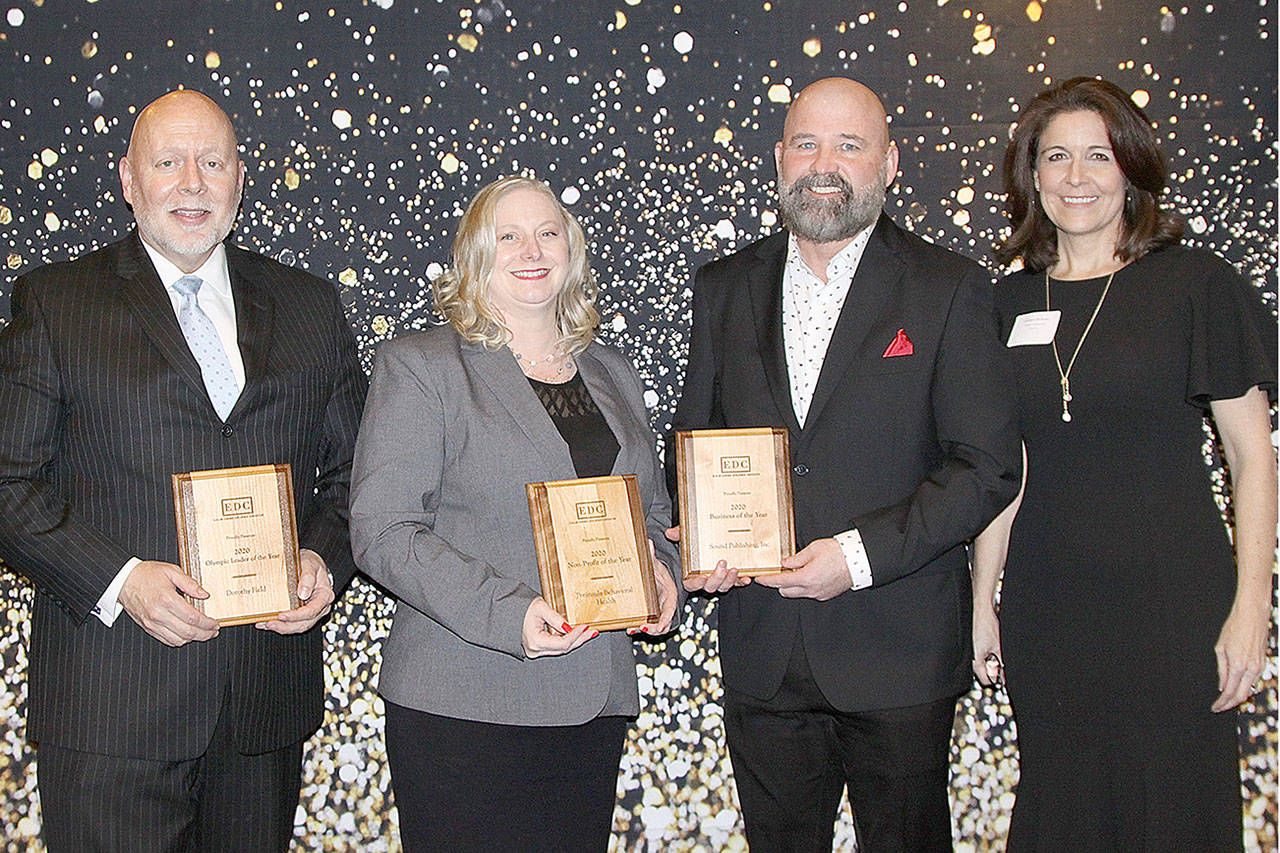 Displaying awards from the Clallam County Economic Development Corp., are, from left, Chris Fidler representing Dorothy Field, recipient of the Olympic Leader of the Year award; Wendy Sisk representing Peninsula Behavioral Health, which was named the Nonprofit of the Year; Terry Ward representing Sound Publishing Inc., which was named Business of the Year; and Colleen McAleer, executive director of the EDC.