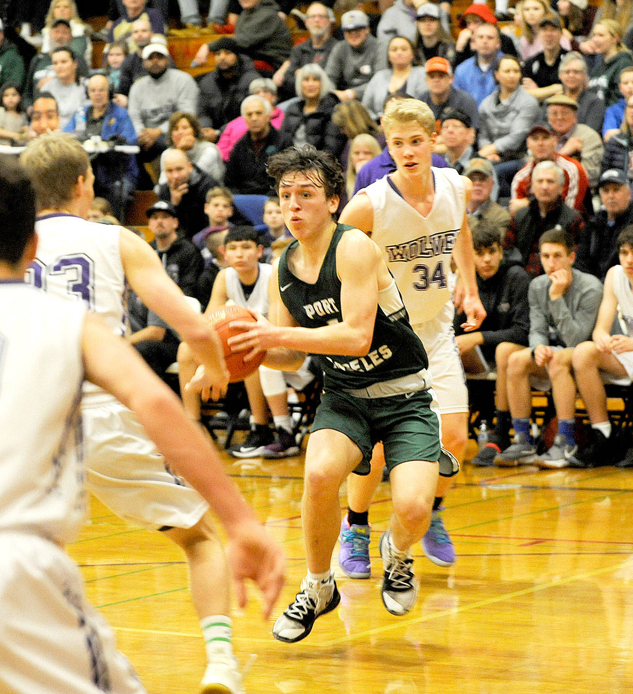 Port Angeles’ Gary Johnson III drives against Sequim on Saturday. Port Angeles won 63-32 to remain in a tie for first place in the Olympic League 2A Division. (Michael Dashiell/Olympic Peninsula News Group)