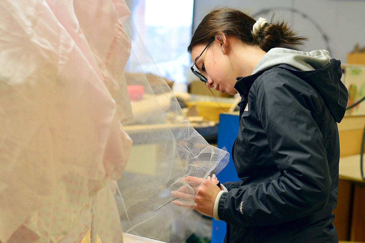 Aurora Faase adjusts the skirt on “Jellyfish,” her piece for the Student Wearable Art Show this Saturday. (Diane Urbani de la Paz/for Peninsula Daily News)                                Aurora Faase adjusts the skirt on “Jellyfish,” her piece for the Student Wearable Art Show this Saturday. (Diane Urbani de la Paz/for Peninsula Daily News)