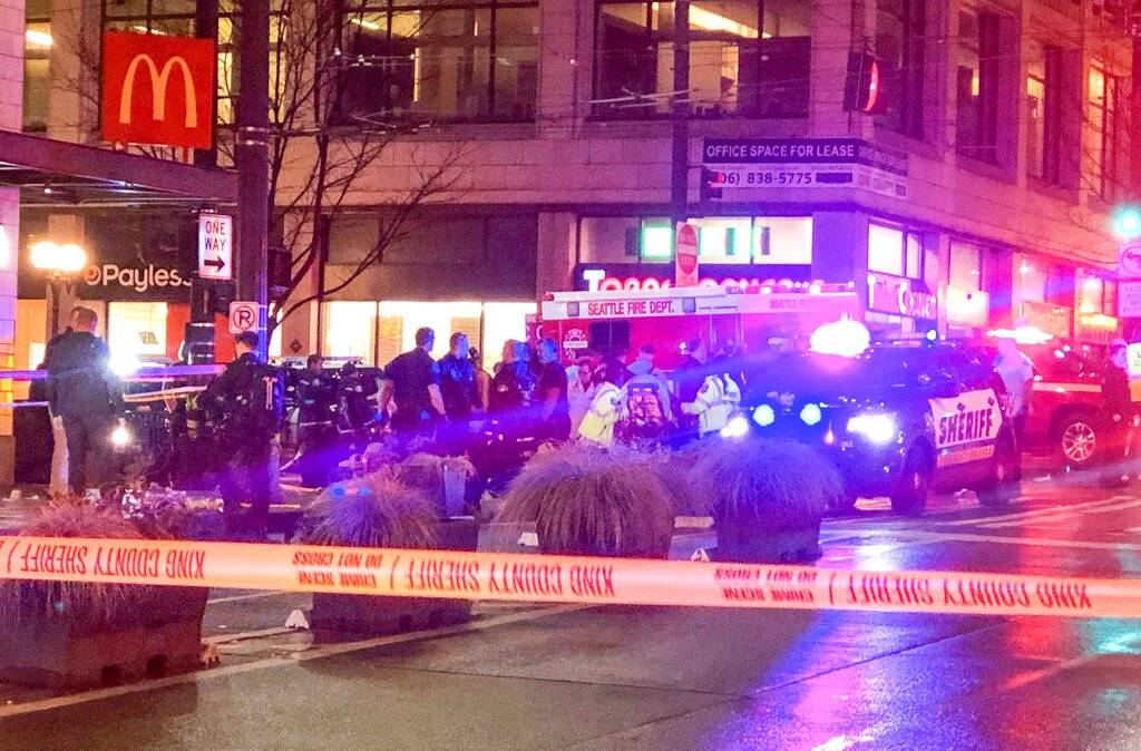 Police work the scene of a shooting on Third Avenue and Pine Street on Wednesday, Jan. 22, 2020, in Seattle. (Amanda Snyder/The Seattle Times via AP)