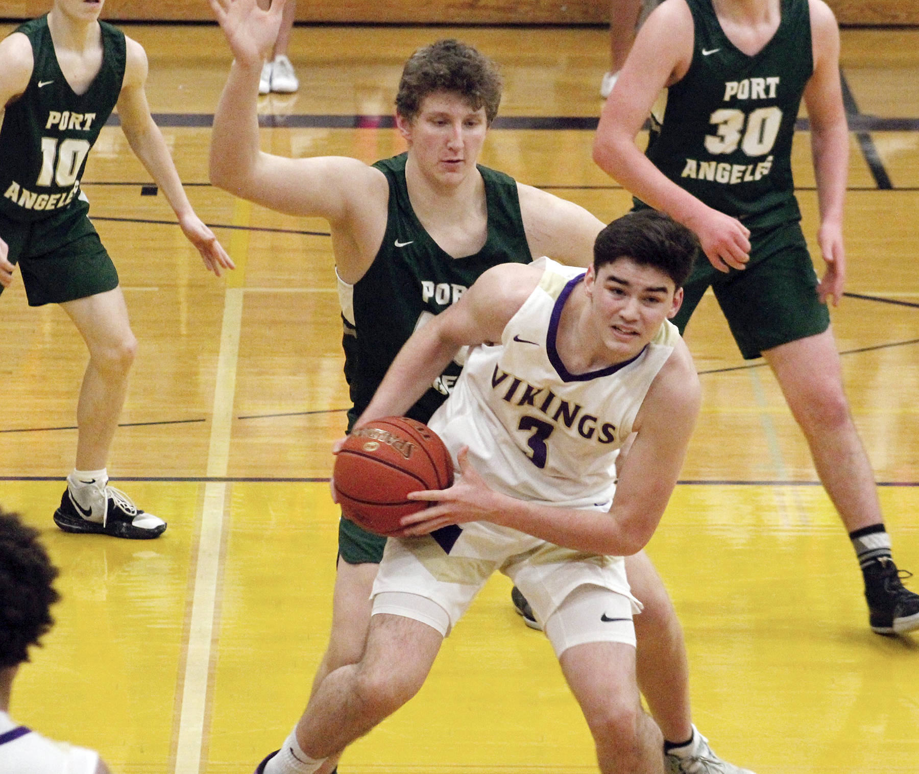 Port Angeles’s John Vaara looks to close off the room to maneuver for North Kitsap’s Aiden Olmstead (Mark Krulish/Kitsap News Group)