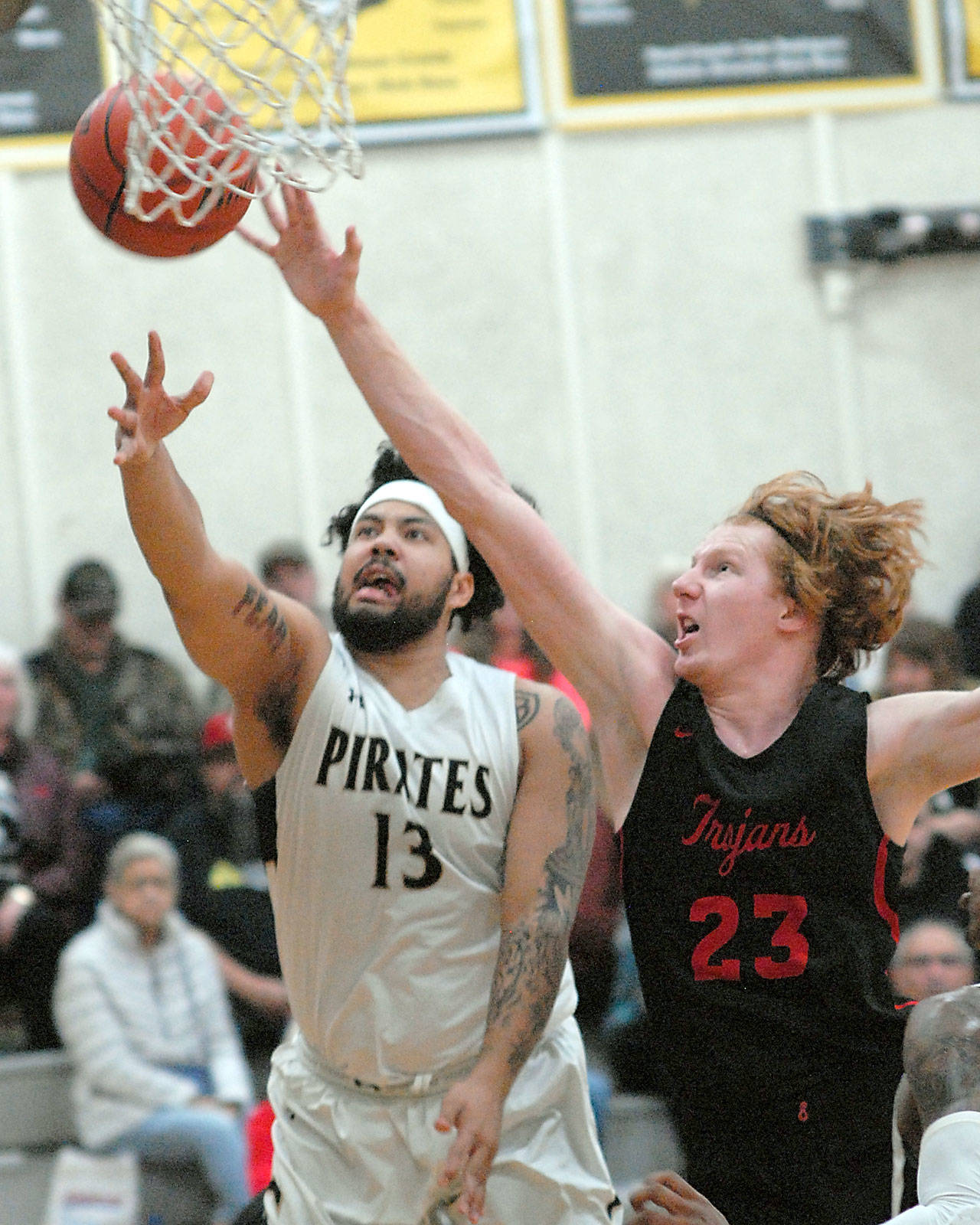 Keith Thorpe/Peninsula Daily News Peninsula’s Marquis Gurske, left, goes for a shot as Everett’s Devin Smith tries to deflect during Saturday night’s matchup at Peninsula College in Port Angeles.