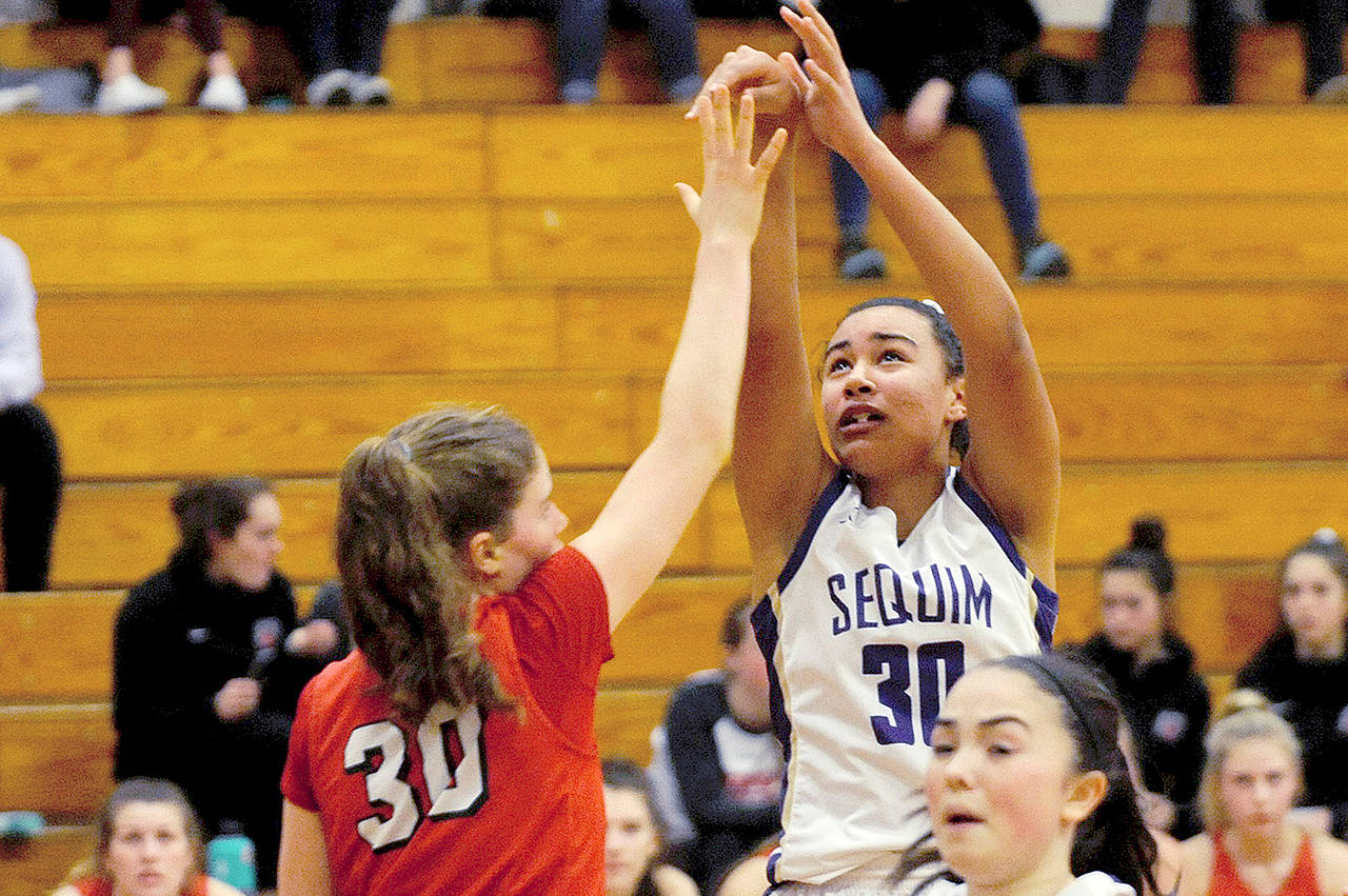 Sequim’s Jayla Julmist (30) pulls back and takes a shot after stealing the ball and running up the court on a fast break in the second quarter of the Wolves’ 60-52 win ove King’s on Wednesday. Julmist made her return from a knee injury, scoring seven points with eight rebounds, three blocks and two steals. (Conor Dowley/Olympic Peninsula News Group)