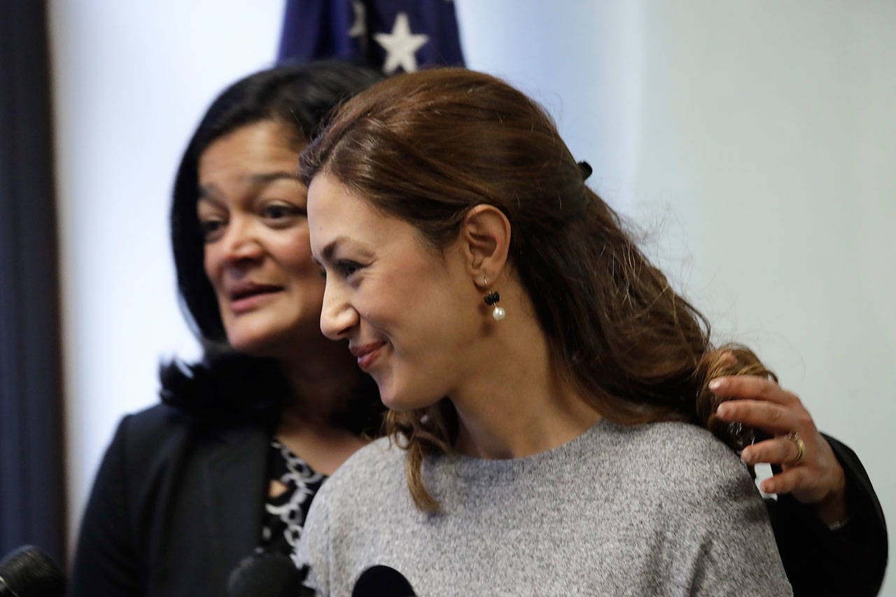 U.S. Rep. Pramila Jayapal, D-Wash., left, turns to Negah Hekmati after Hekmati spoke on Jan. 6 about her hours-long delay returning to the U.S. from Canada with her family days earlier, at a news conference in Seattle. (Elaine Thompson/The Associated Press)