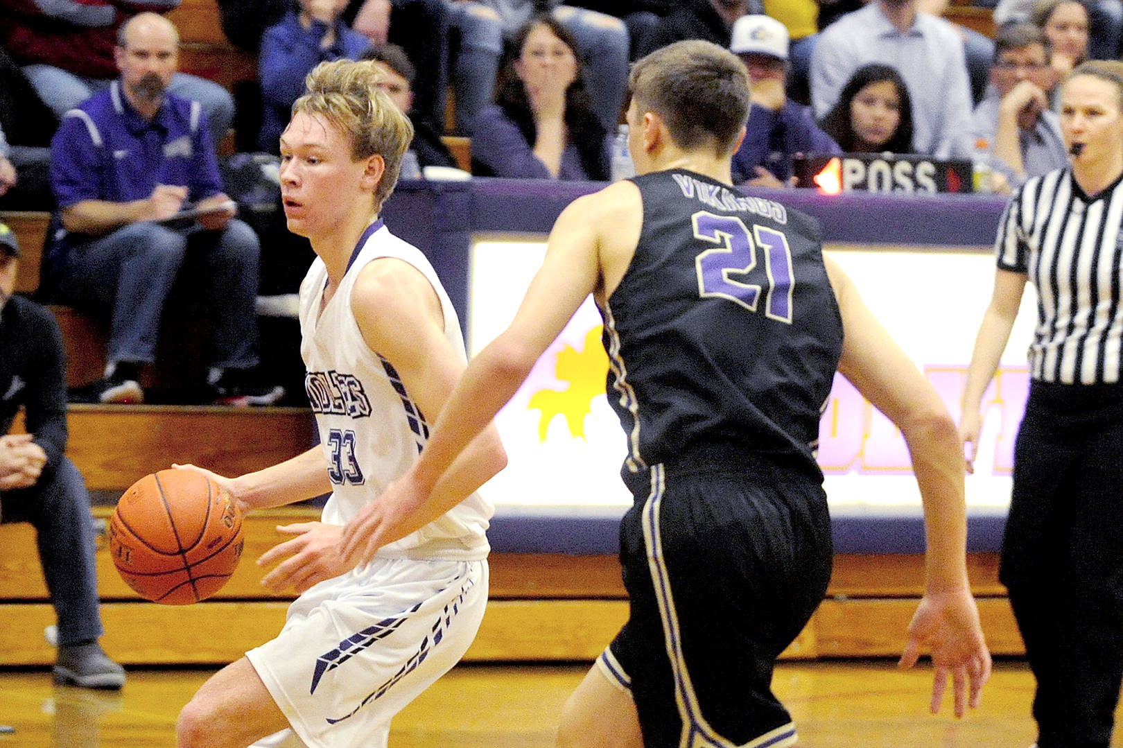 Conor Duncan/Olympic Peninsula News Group Stew Duncan (33) of Sequim brings the ball up the court against North Kitsap’s Logan Chmielewski (21) on Friday night in Sequim.