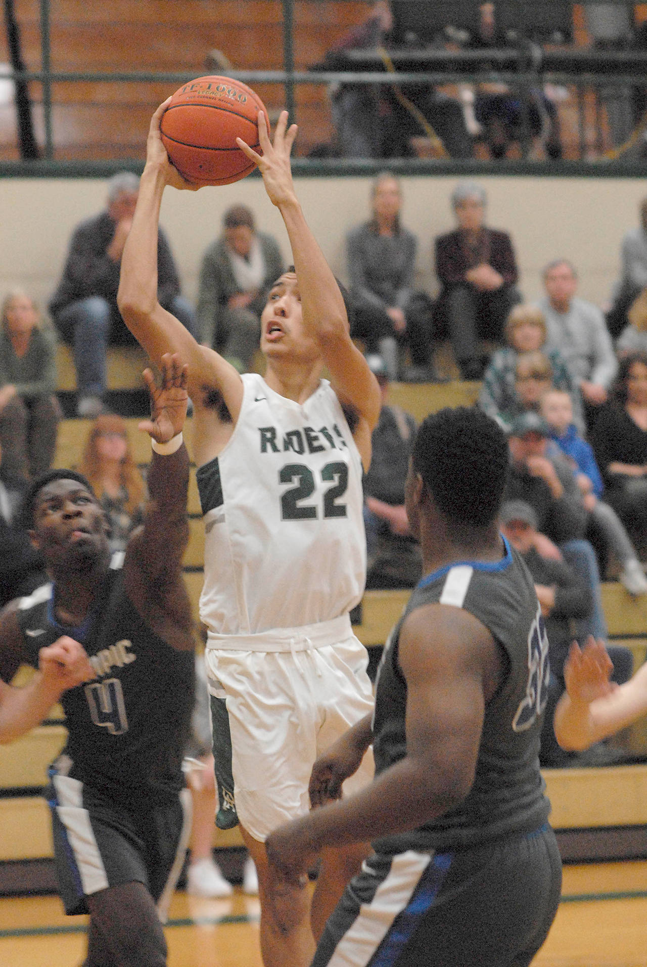 Keith Thorpe/Peninsula Daily News Port Angeles’ Damen Ringgold, center, rises to shoot the basketball during a home win over Olympic earlier this season. Ringgold was cut from the program as a freshman and has risen through the program’s ranks to become the team’s leading scorer and rebounder in his senior season.