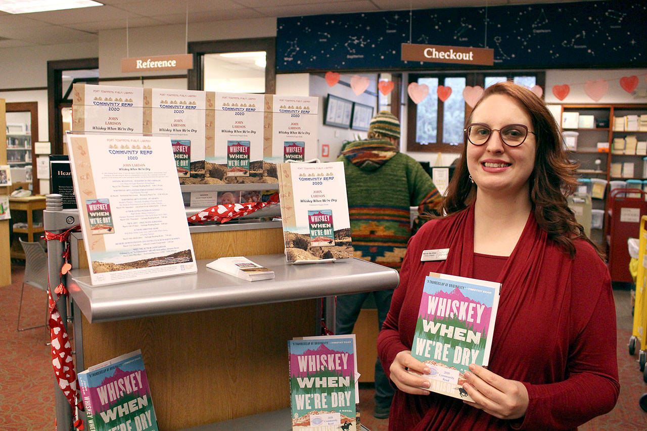 Port Townsend Public Library director Melody Eisler holds this year’s community read book “Whiskey When We’re Dry” by John Larison. The book was announced at the Port Townsend City Council meeting Monday, Feb. 3, 2020. (Zach Jablonski/Peninsula Daily News)