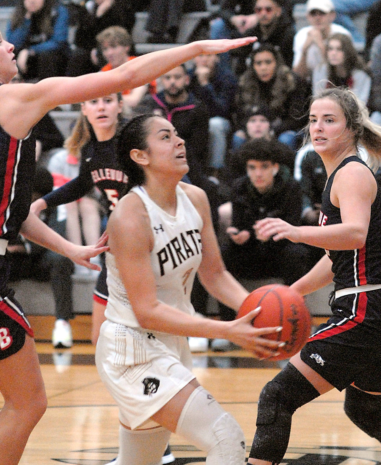 Peninsula’s Leillani Padilla, center, is surrounded by the Bellevue defense of, from left, Rokki Brown, Natalie Amos and Makenna Faulkner on Wednesday on the Pirate home court in Port Angeles. (Keith Thorpe/Peninsula Daily News)