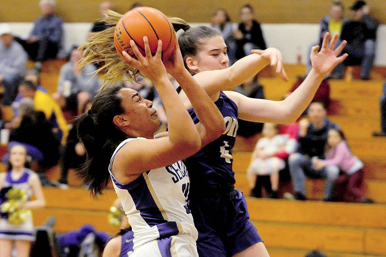 Conor Dowley/Olympic Peninsula News Group Sequim’s Jayla Julmist (left) prepares to shoot while defended by North Kitsap’s Sophia Baugh earlier this season