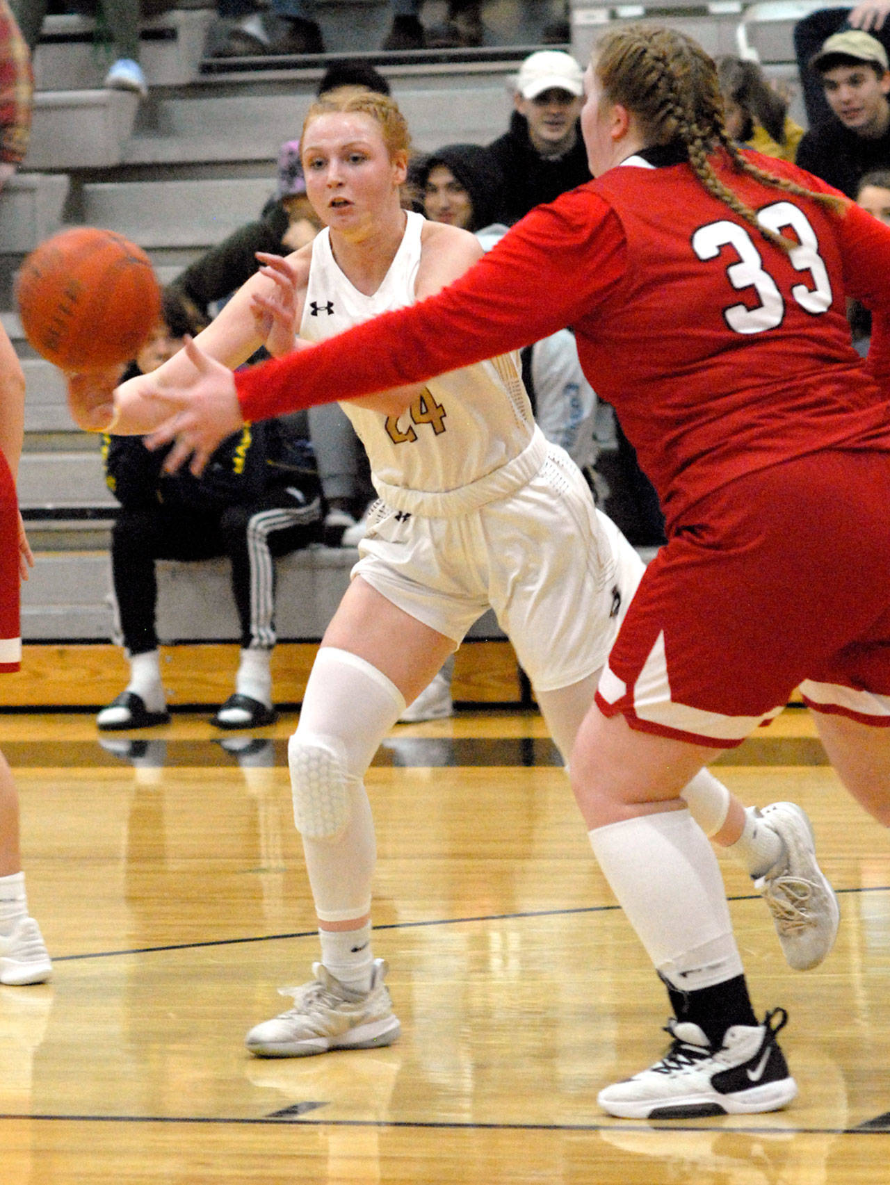 Keith Thorpe/Peninsula Daily News Peninsula’s Kameron Bowen, left, makes a pass as Skagit Valley’s Melissa Frein defends on Wednesday night in Port Angeles.