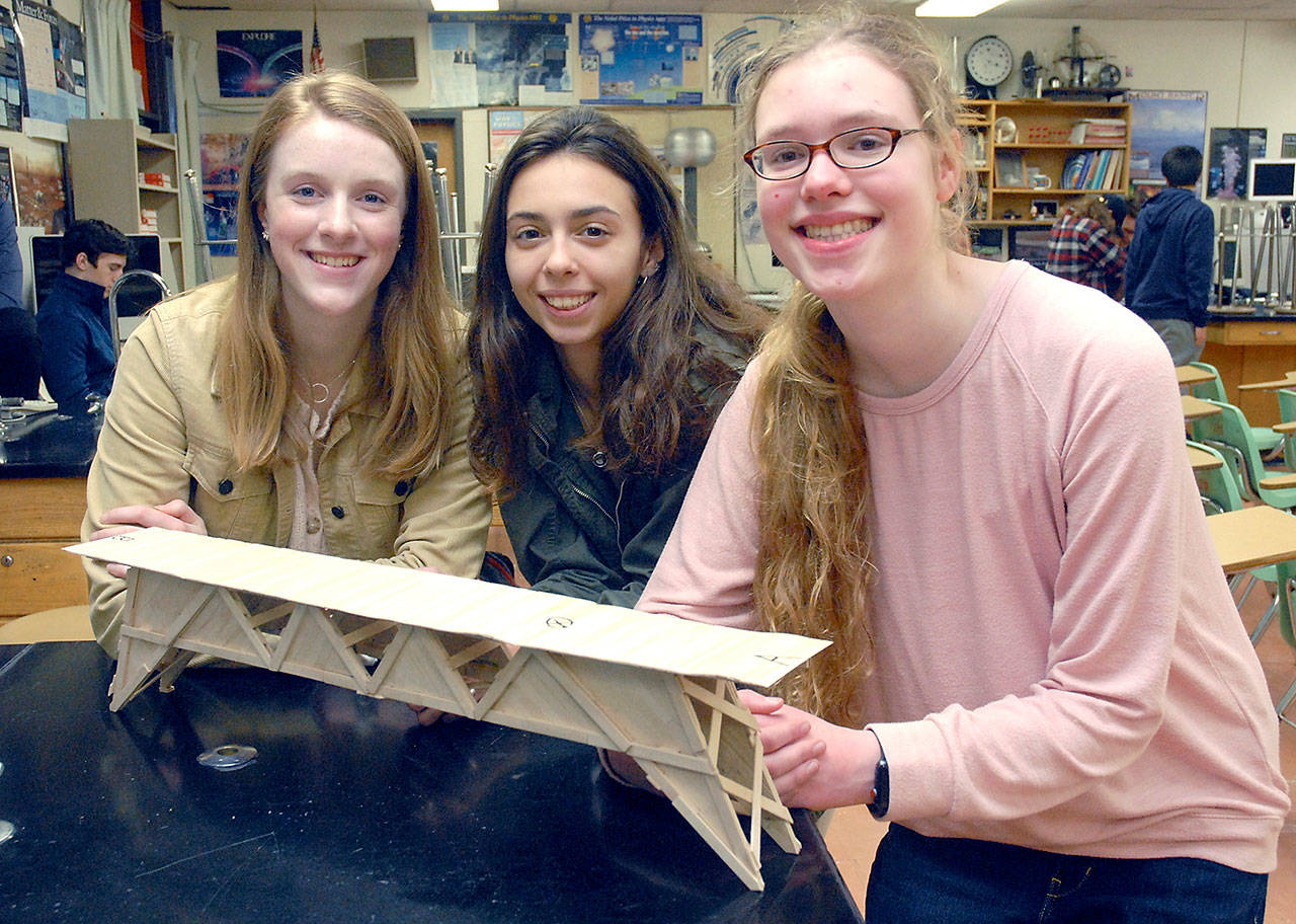 Port Angeles High School students, from left, Emily Sirguy, Kynzie Deleon and Emma Weller display their award-winning bridge on Wednesday after taking first place in the 2020 Popsicle Bridge Competition held Feb 8 in Seattle. (Keith Thorpe/Peninsula Daily News)