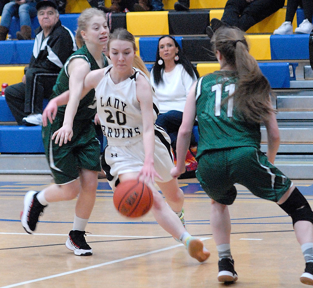 Keith Thorpe/Peninsula Daily News Clallam Bay’s Cedar Johnson, center, cuts between Cedar Park Christian’s Trifine Worrell, left, and Parker Reymore on Saturday in Joyce.