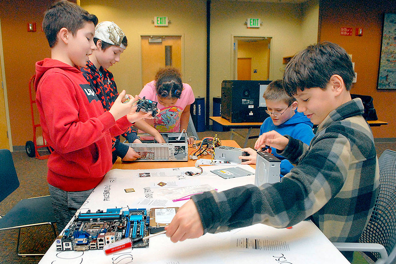 Children crack open computers at Port Angeles Library teardown event