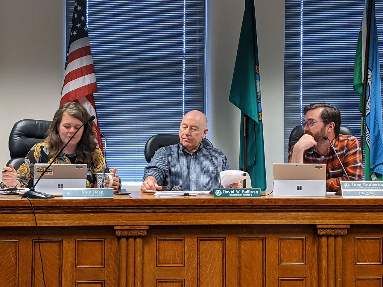 Jefferson County commissioners Kate Dean, left, David Sullivan and Greg Brotherton discuss the changes to two ordinances on shooting ranges and limiting future ranges to indoors only during their meeting Monday. (Zach Jablonski/Peninsula Daily News)