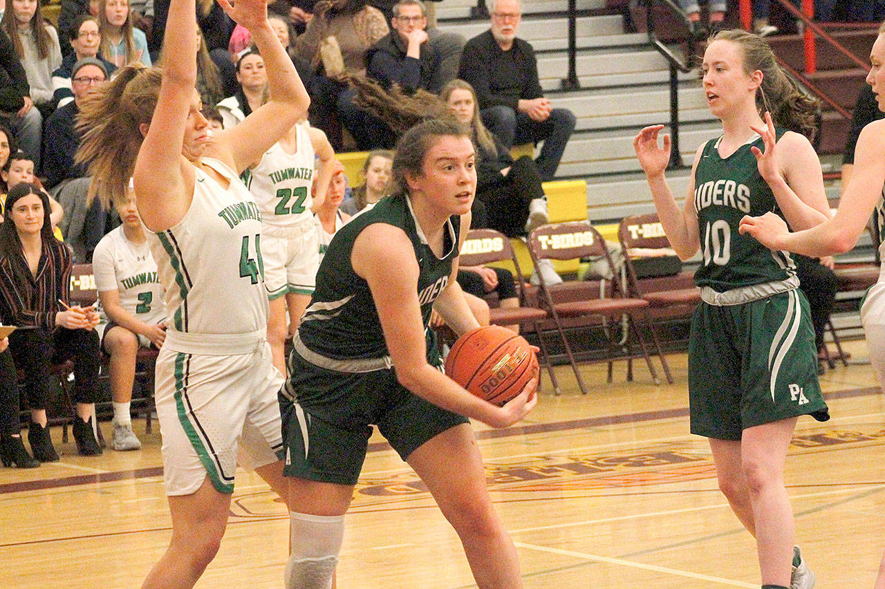 Port Angeles’ Jaida Wood looks to pass against Tumwater in the Roughriders’ 58-57 loss Saturday at Mount Tahoma High School. At right is the Riders’ Mikkiah Brady. (Mark Krulish/Kitsap News Group)