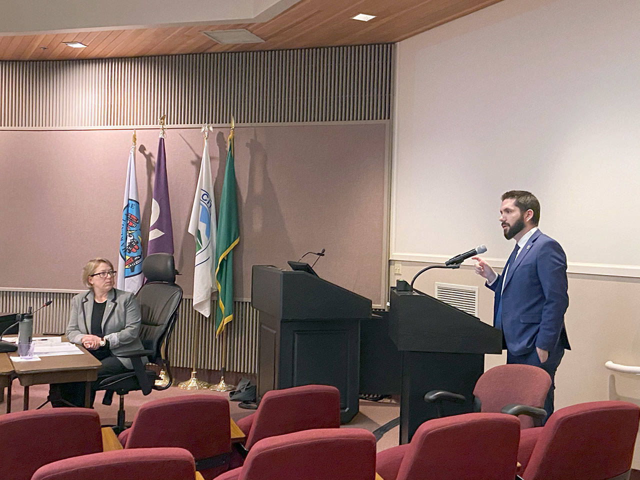 Port Angeles mayor Kate Dexter, left, listens as Public Works and Utilities Director Thomas Hunter explains a paving project to the Port Angeles City Council. (Rob Ollikainen/Peninsula Daily News)