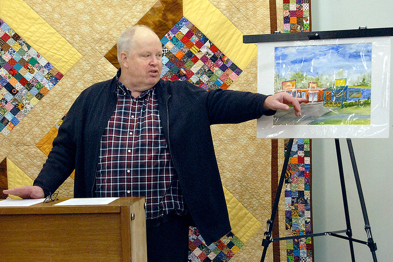 Richard “Doc” Robinson, executive director of Serenity House of Clallam County, points to an artist’s rendering of the Bridges Grill and a nearby laundromat on Eighth Street in Port Angeles that were under consideration for purchase by his agency to provide services for homeless young adults in this Dec. 15, 2018, file photo. Robinson has left his post at Serenity House. (Keith Thorpe/Peninsula Daily News file)