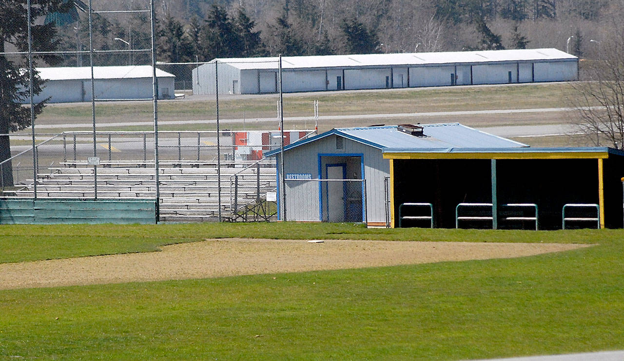 Grandstands and the home team dugout at Volunteer Field in Port Angeles sit vacant Tuesday, April 7, 2020, after the cancellation of the spring season of high school baseball because of the COVID-19 health emergency. (Keith Thorpe/Peninsula Daily News)